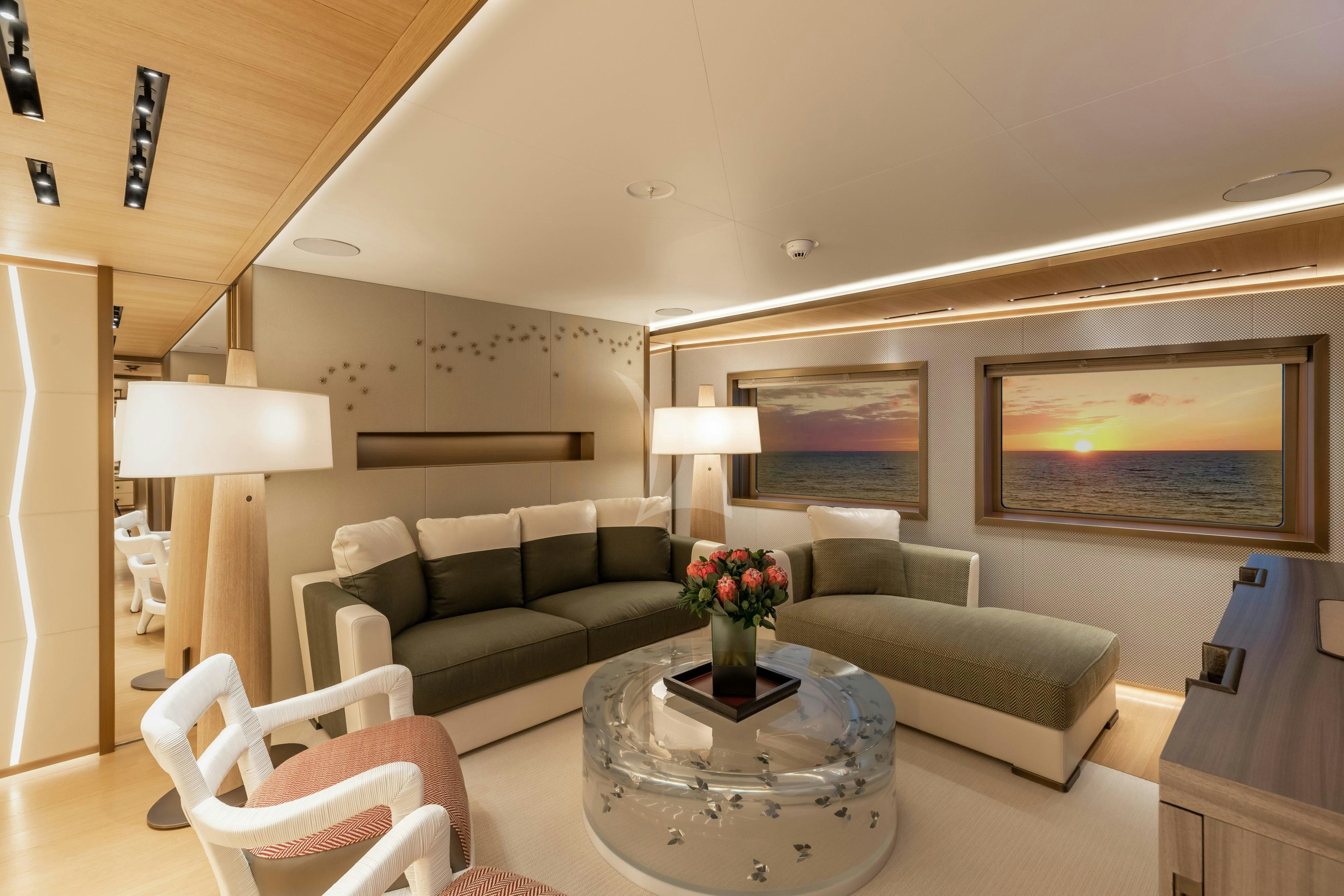 a living room with a couch and a table aboard LA DATCHA Yacht for Charter