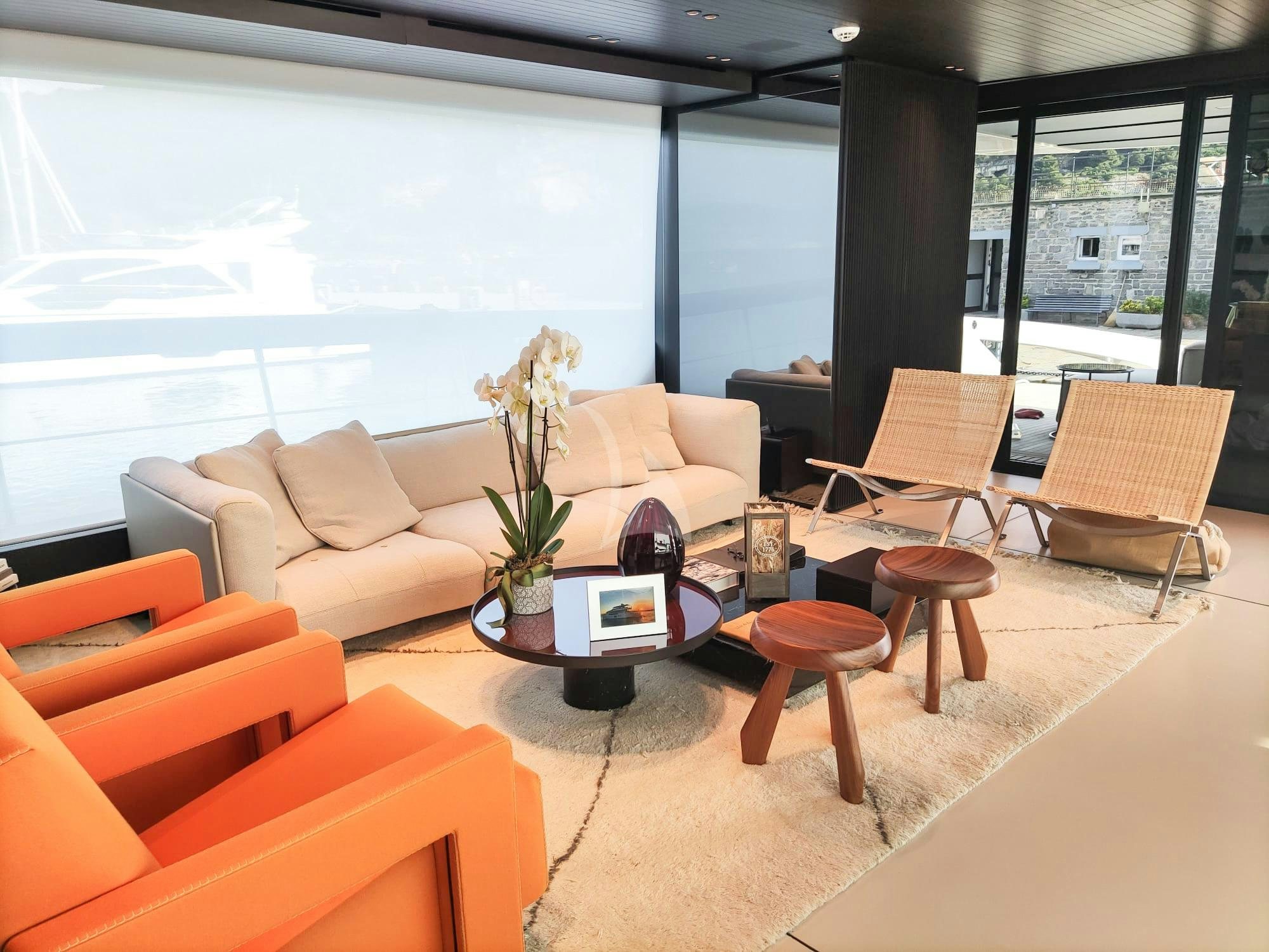 a living room with a large window aboard LUAR Yacht for Charter