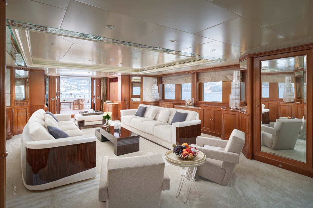 a living room with white furniture aboard COME PRIMA Yacht for Charter