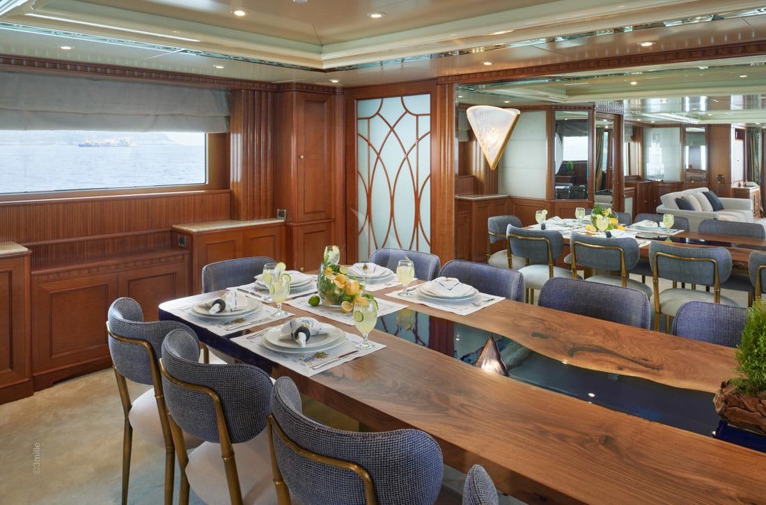 a room with tables and chairs aboard COME PRIMA Yacht for Charter