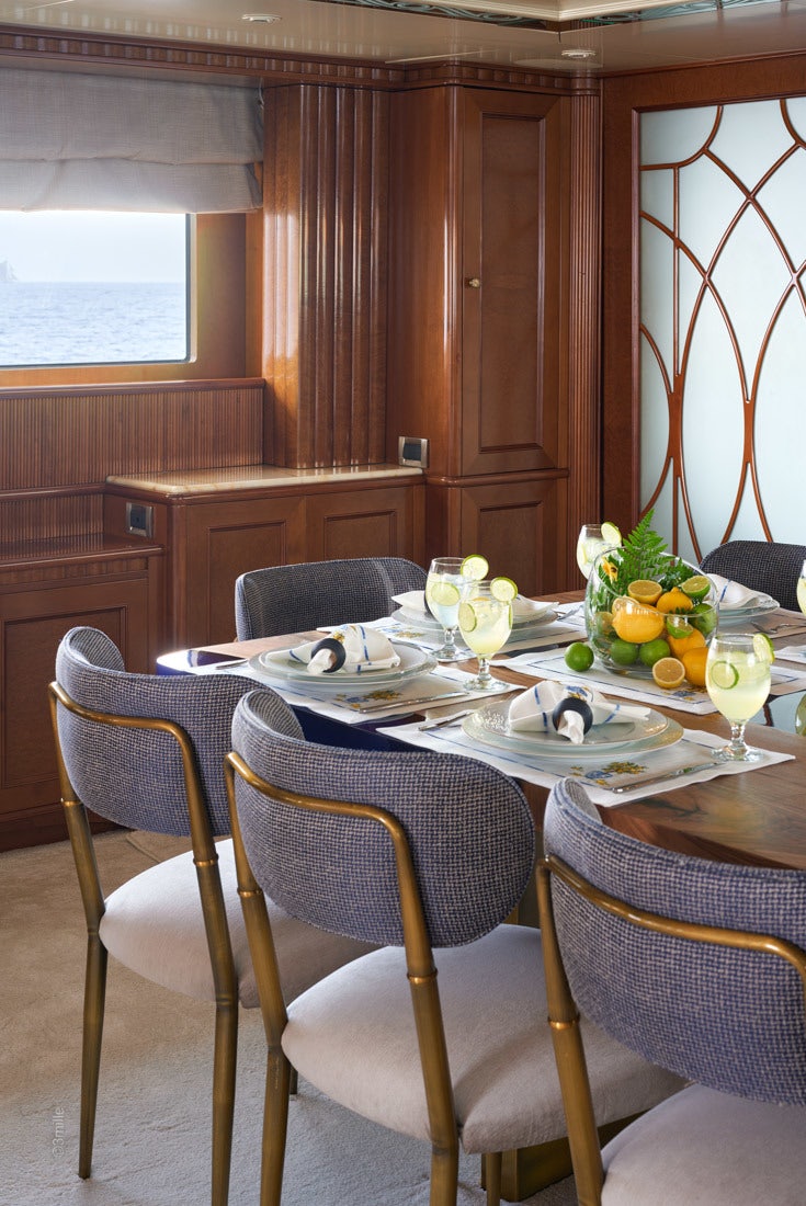 a table with chairs and a plate of food on it aboard COME PRIMA Yacht for Charter