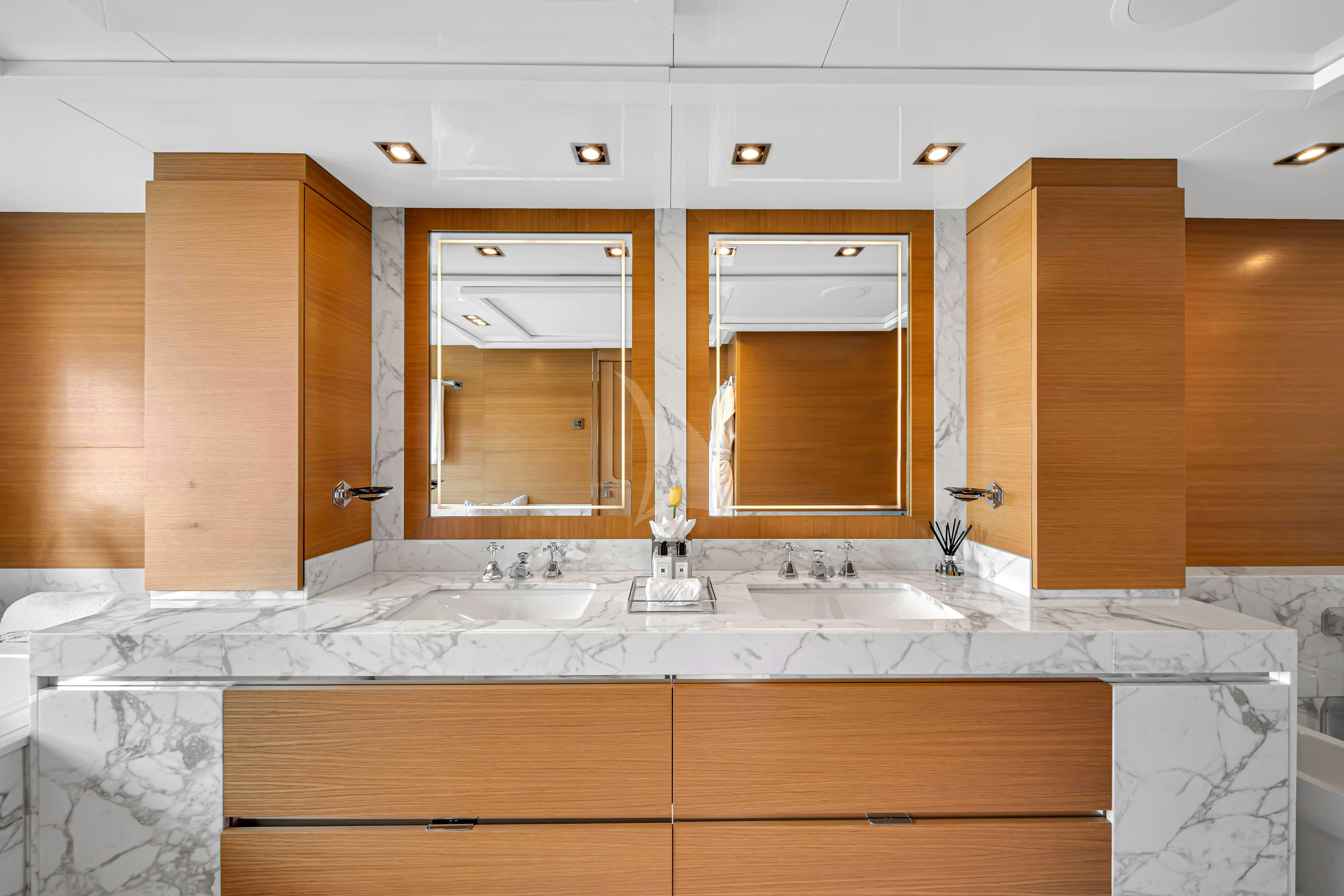 a bathroom with a countertop sink and cabinets aboard DB9 Yacht for Charter