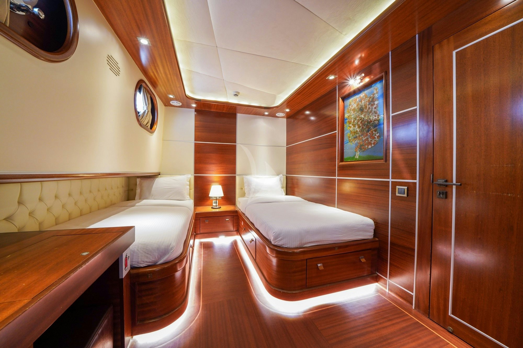 a room with a bed and a mirror aboard LA BELLA VITA Yacht for Charter