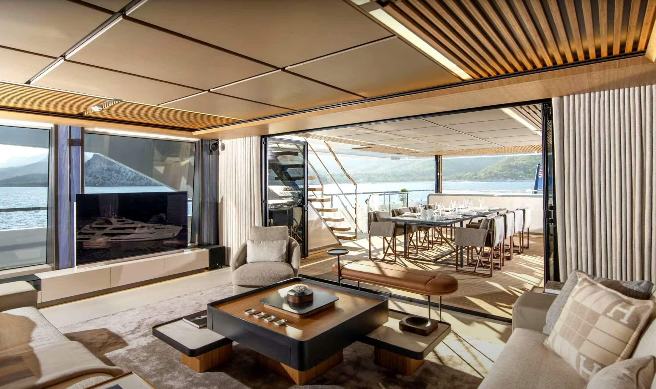 a living room with a large screen aboard AL WAAB Yacht for Charter