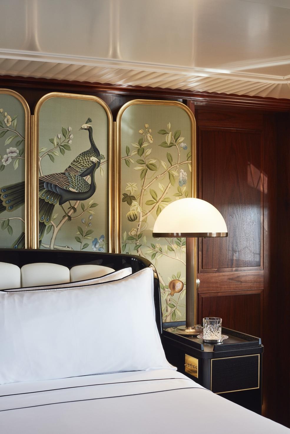 a room with a bed and a lamp aboard MARALA Yacht for Charter