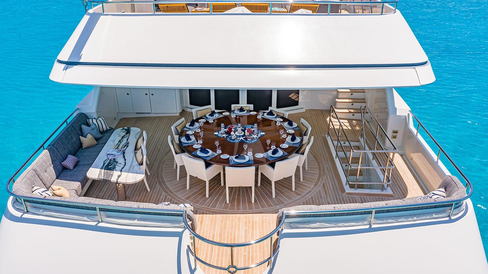 a boat with chairs on the deck aboard CROSSED SABRE Yacht for Charter