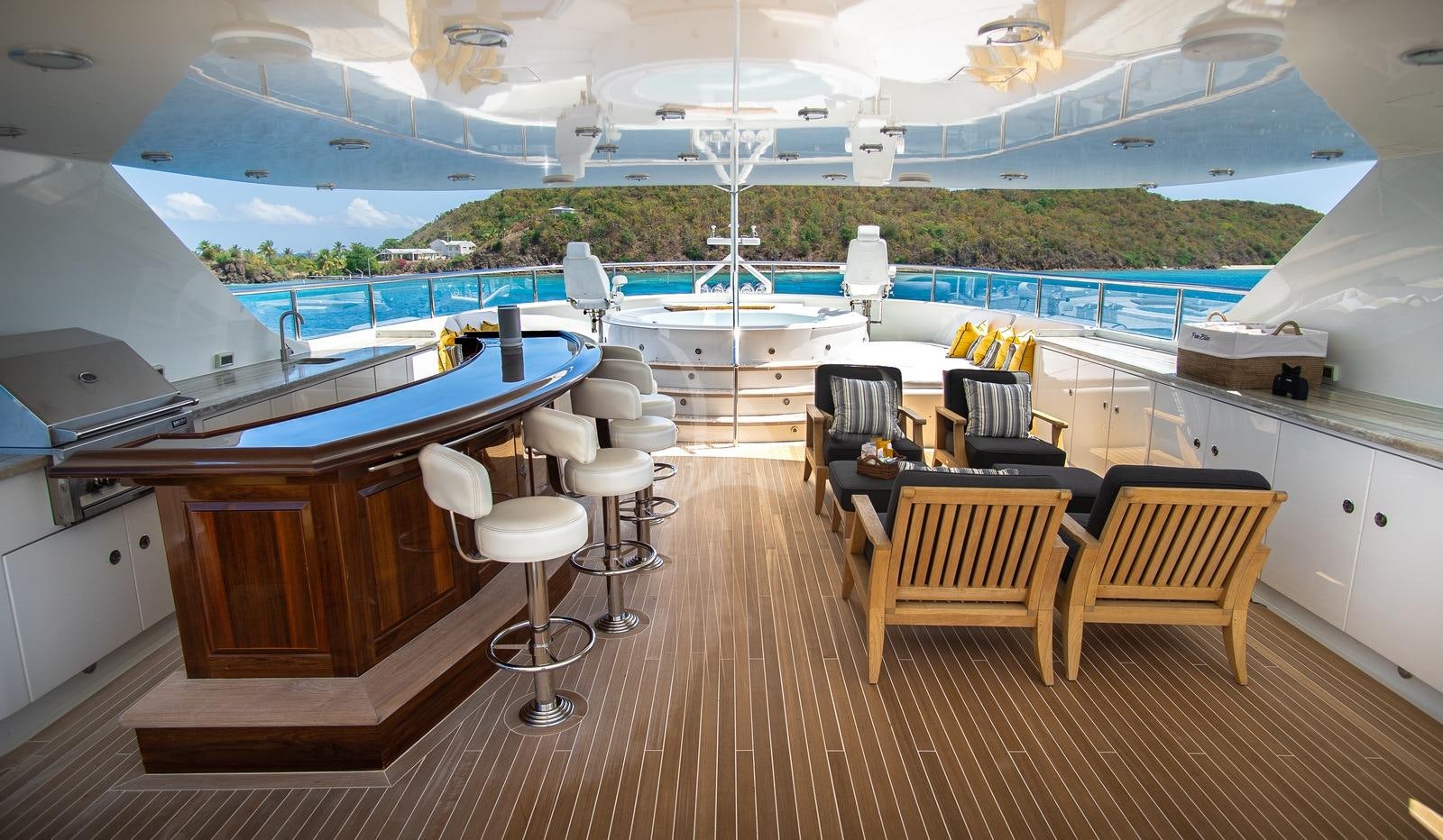 a room with a pool and a table and chairs aboard CROSSED SABRE Yacht for Charter