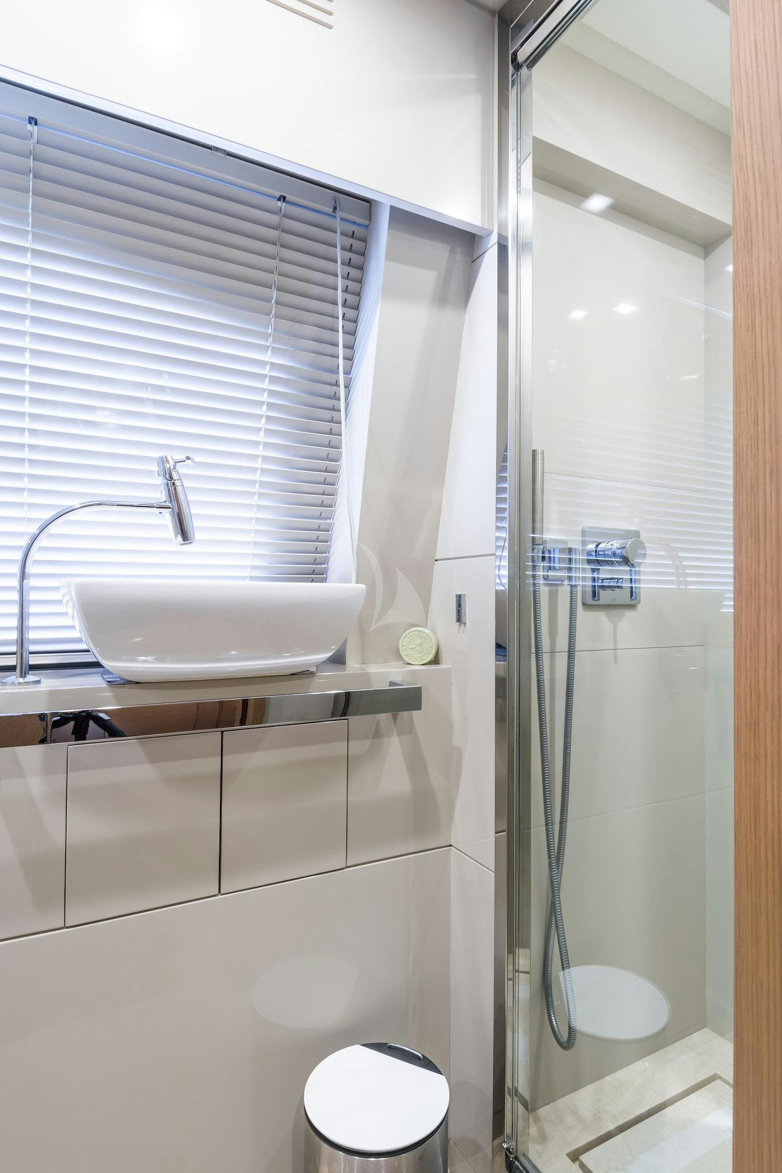 a bathroom with a sink and a shower aboard THALYSSA Yacht for Charter