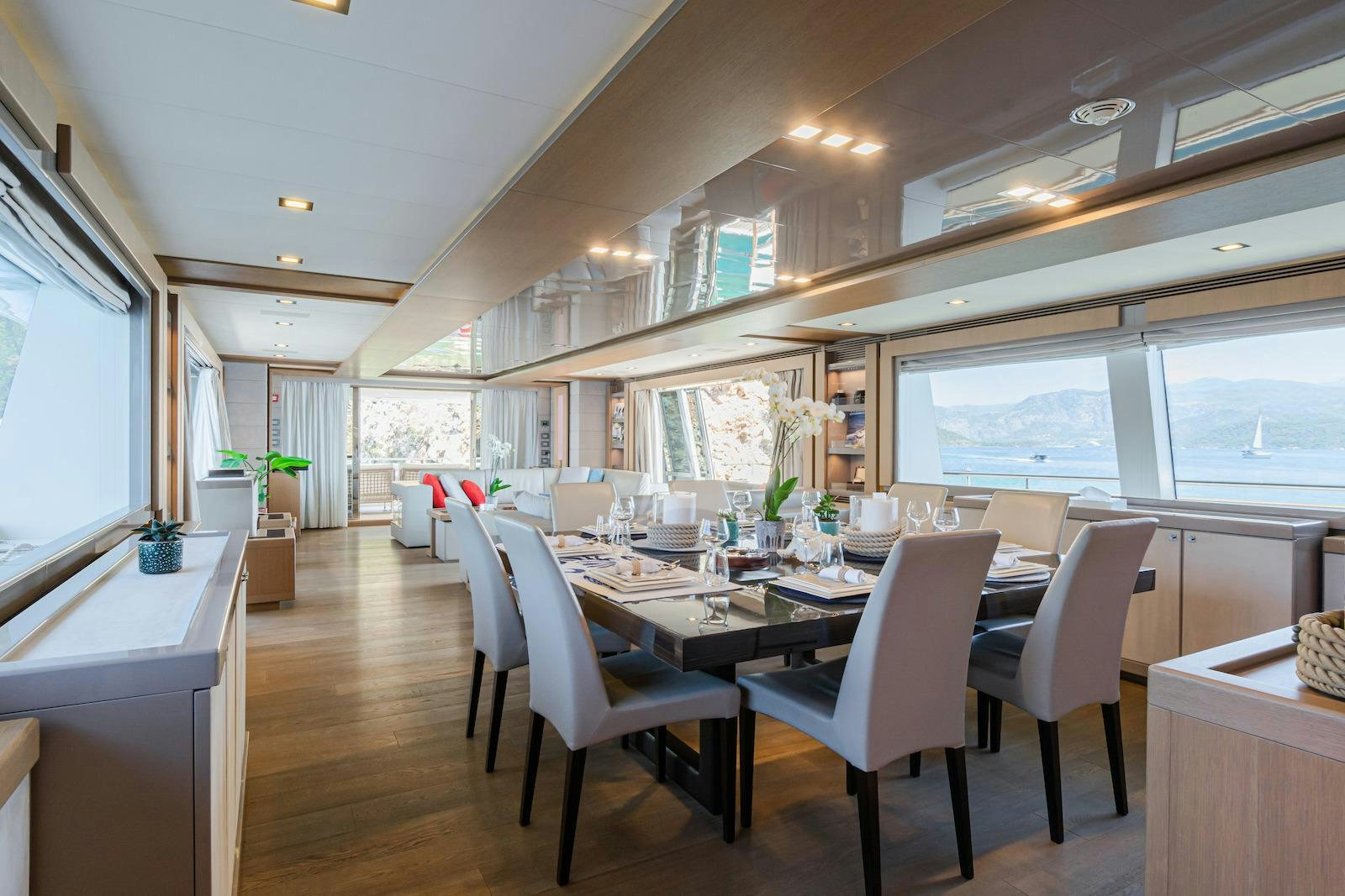 a room with tables and chairs aboard THALYSSA Yacht for Charter