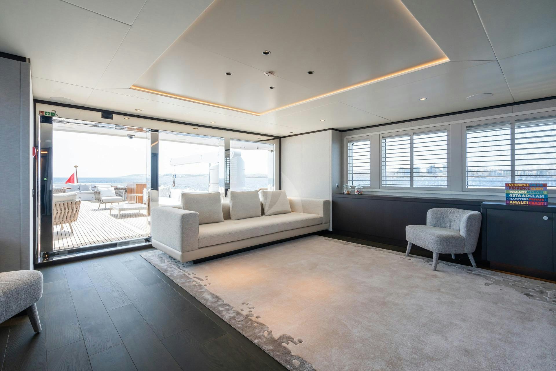 a room with a couch and a table and chairs aboard EMERALD Yacht for Sale