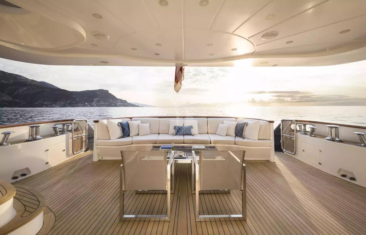 a large living room with a large balcony overlooking the ocean aboard SOHO Yacht for Charter