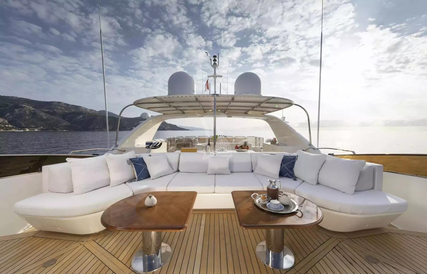 a large white lounge chair next to a large white sofa and a large white sofa with a large aboard SOHO Yacht for Charter