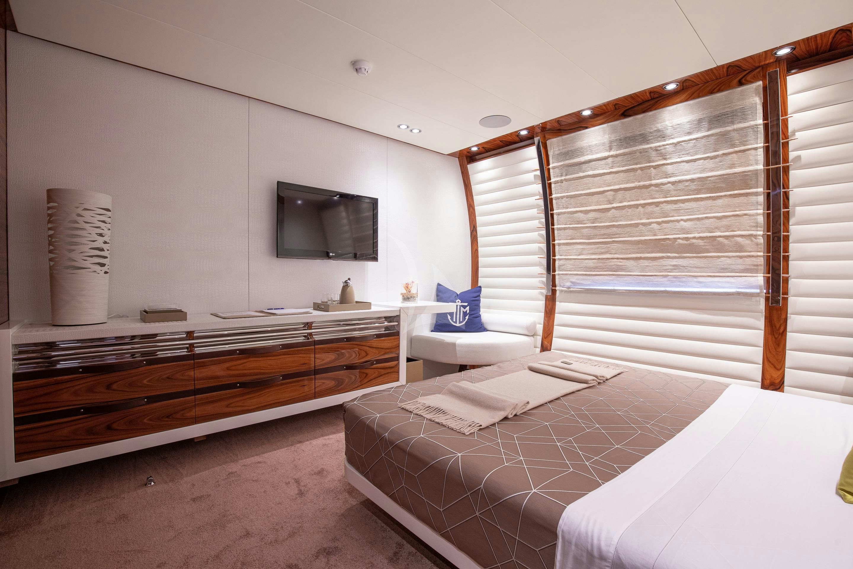 a room with a bed and a television aboard HATT MILL Yacht for Charter