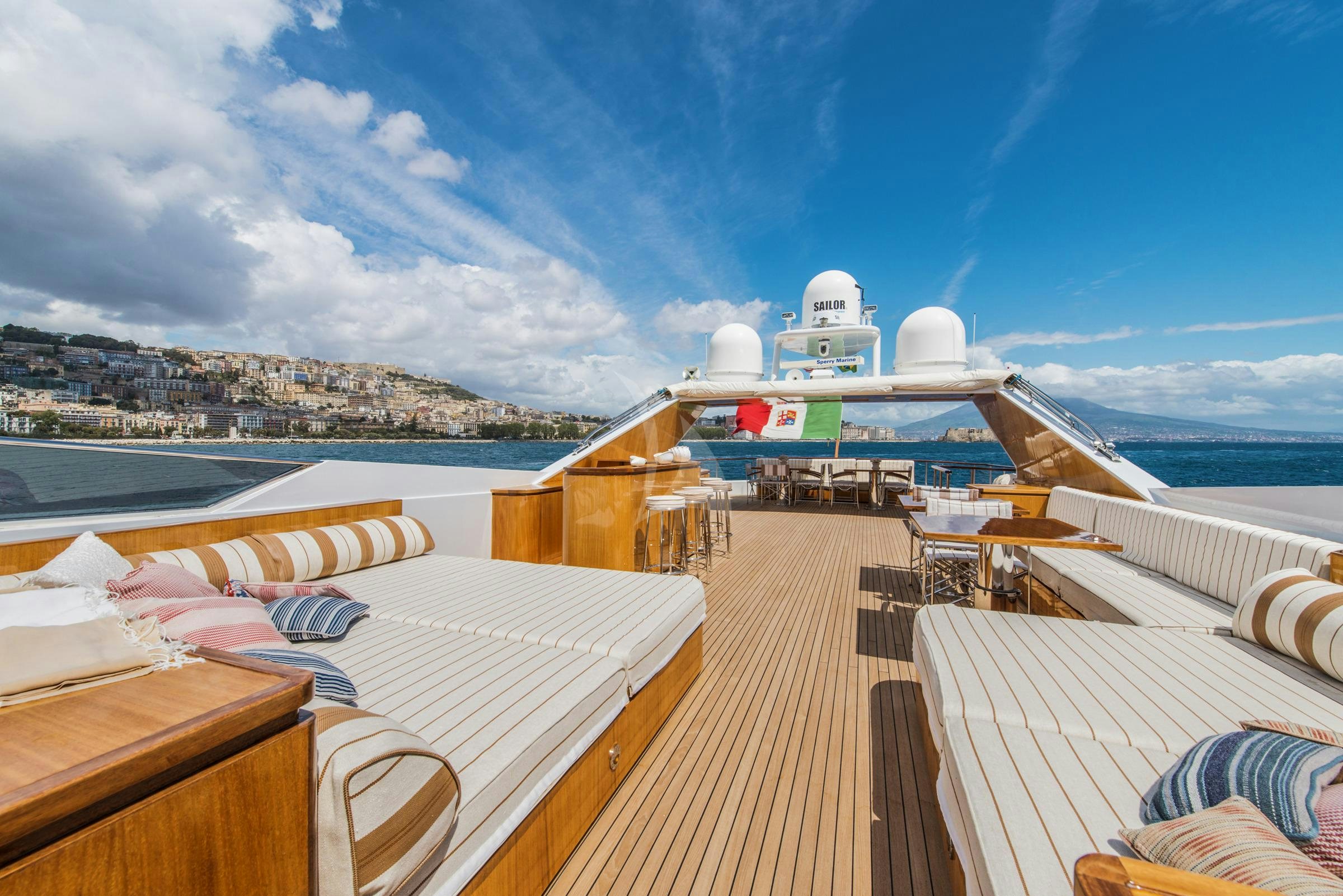 a deck with a large ship in the water aboard ANGRA TOO Yacht for Charter