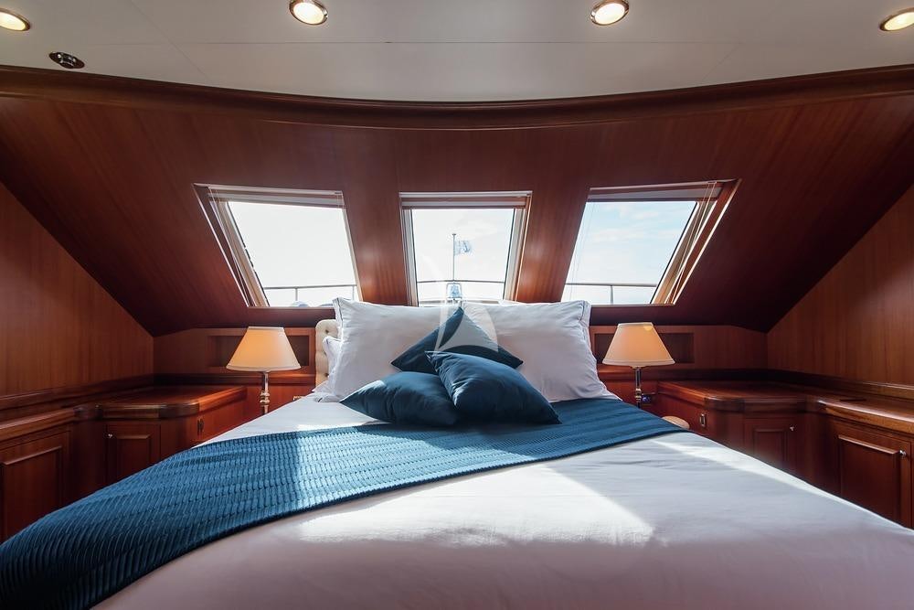 a bed with pillows aboard ELENI Yacht for Charter