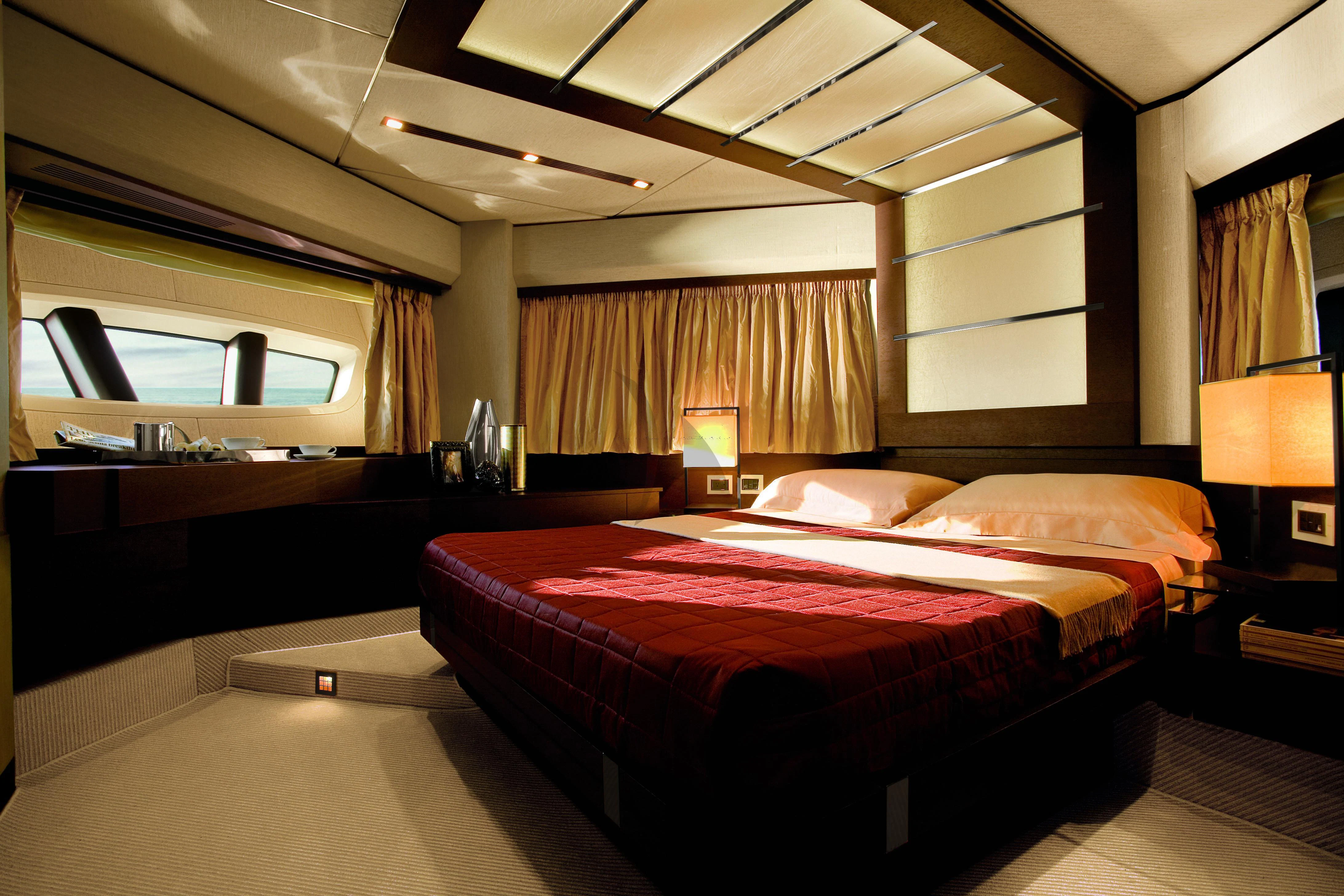 a room with a bed and a desk aboard DUKE Yacht for Charter