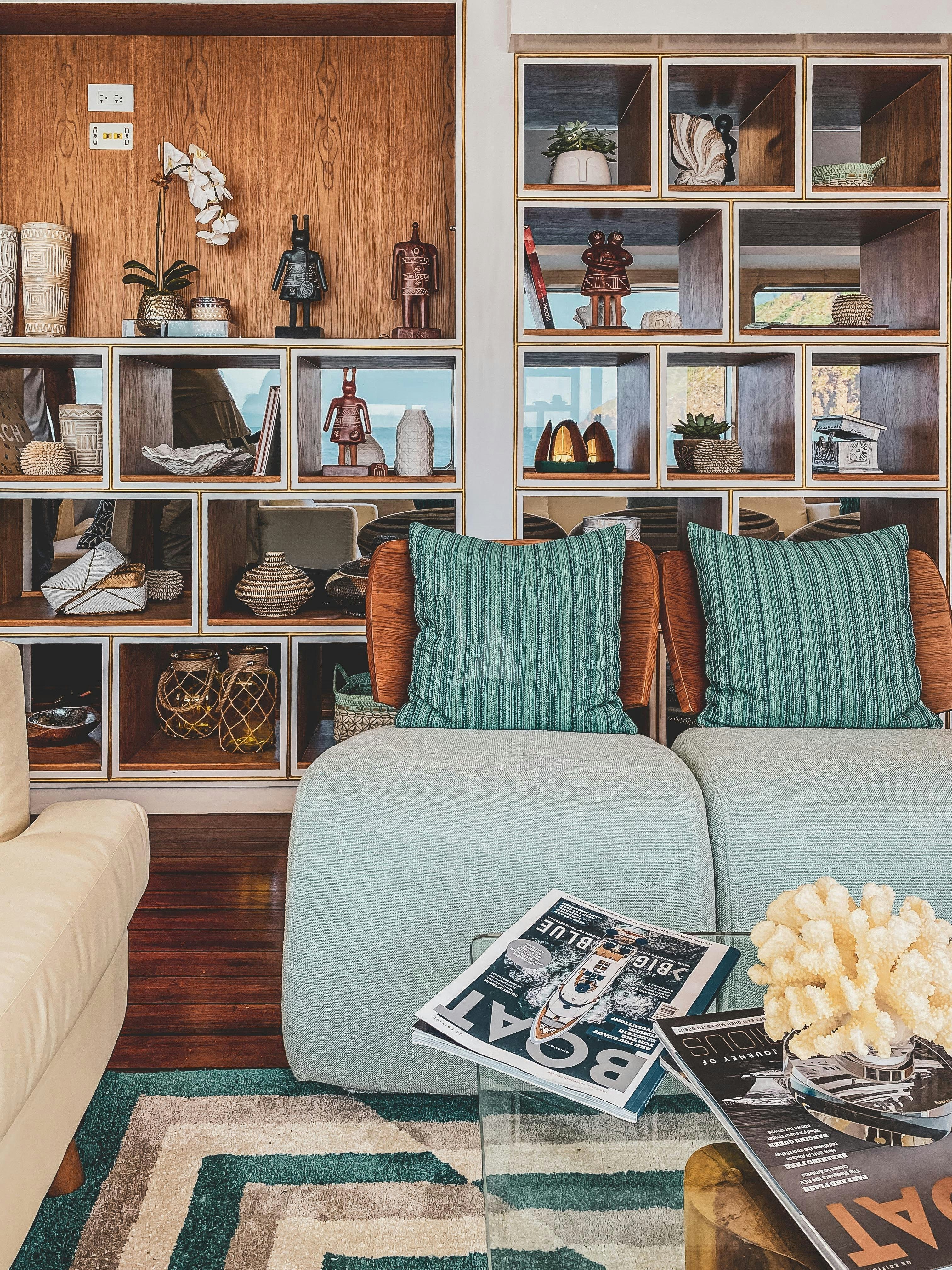 a living room with a book and a flower on the couch aboard KONTIKI WAYRA Yacht for Charter