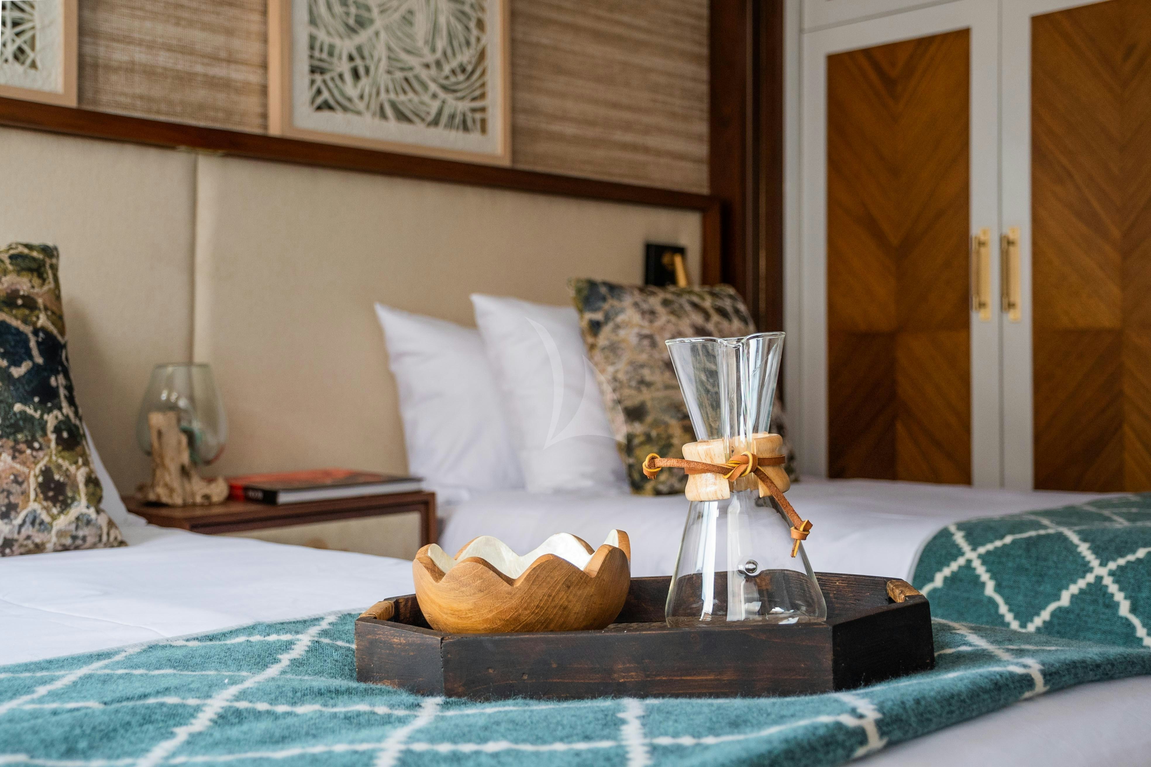 a bed with a tray of food aboard KONTIKI WAYRA Yacht for Charter