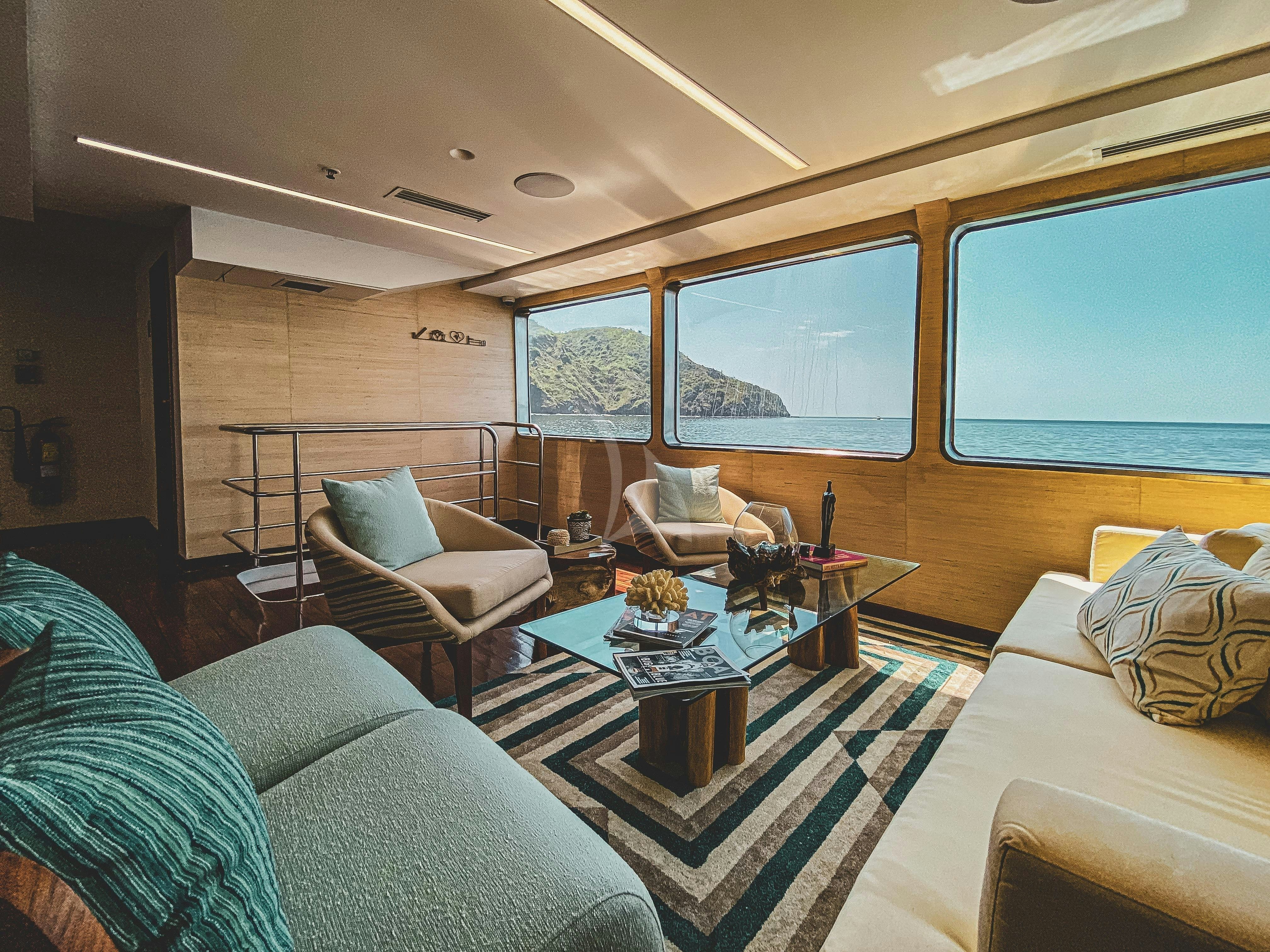 a living room with a large window aboard KONTIKI WAYRA Yacht for Charter
