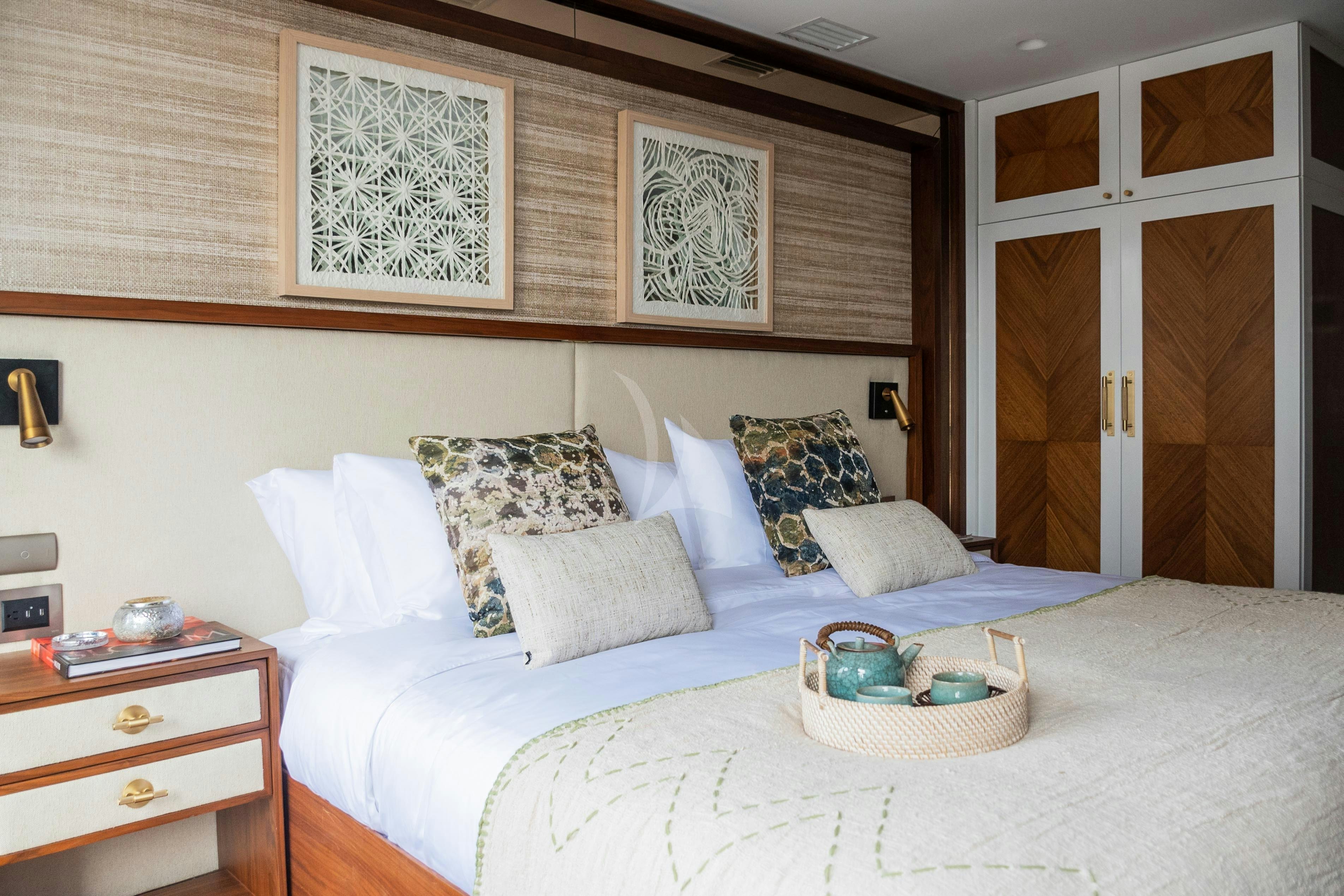 a bed with white sheets and pillows aboard KONTIKI WAYRA Yacht for Charter