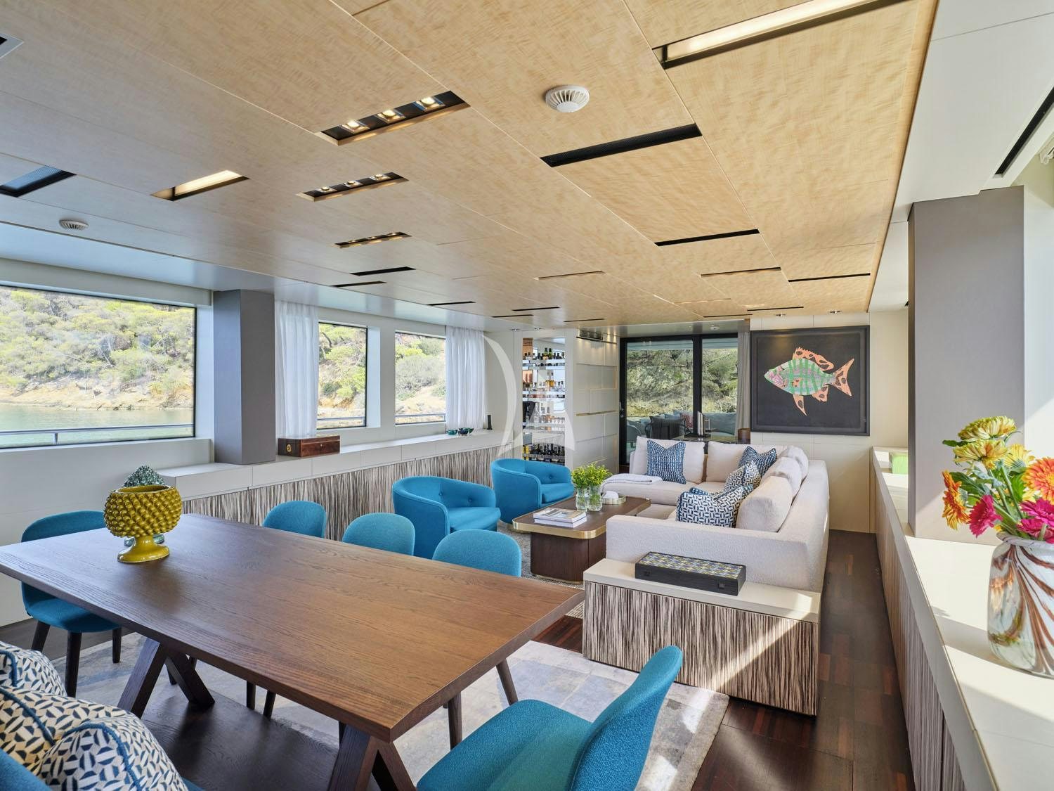 a living room with a table and couches aboard RARE DIAMOND Yacht for Charter