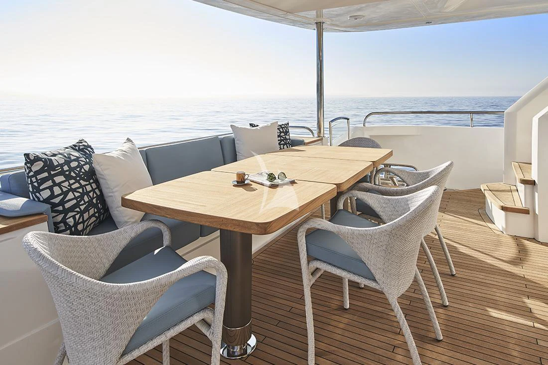a table with chairs on it aboard HALLELUJAH Yacht for Charter