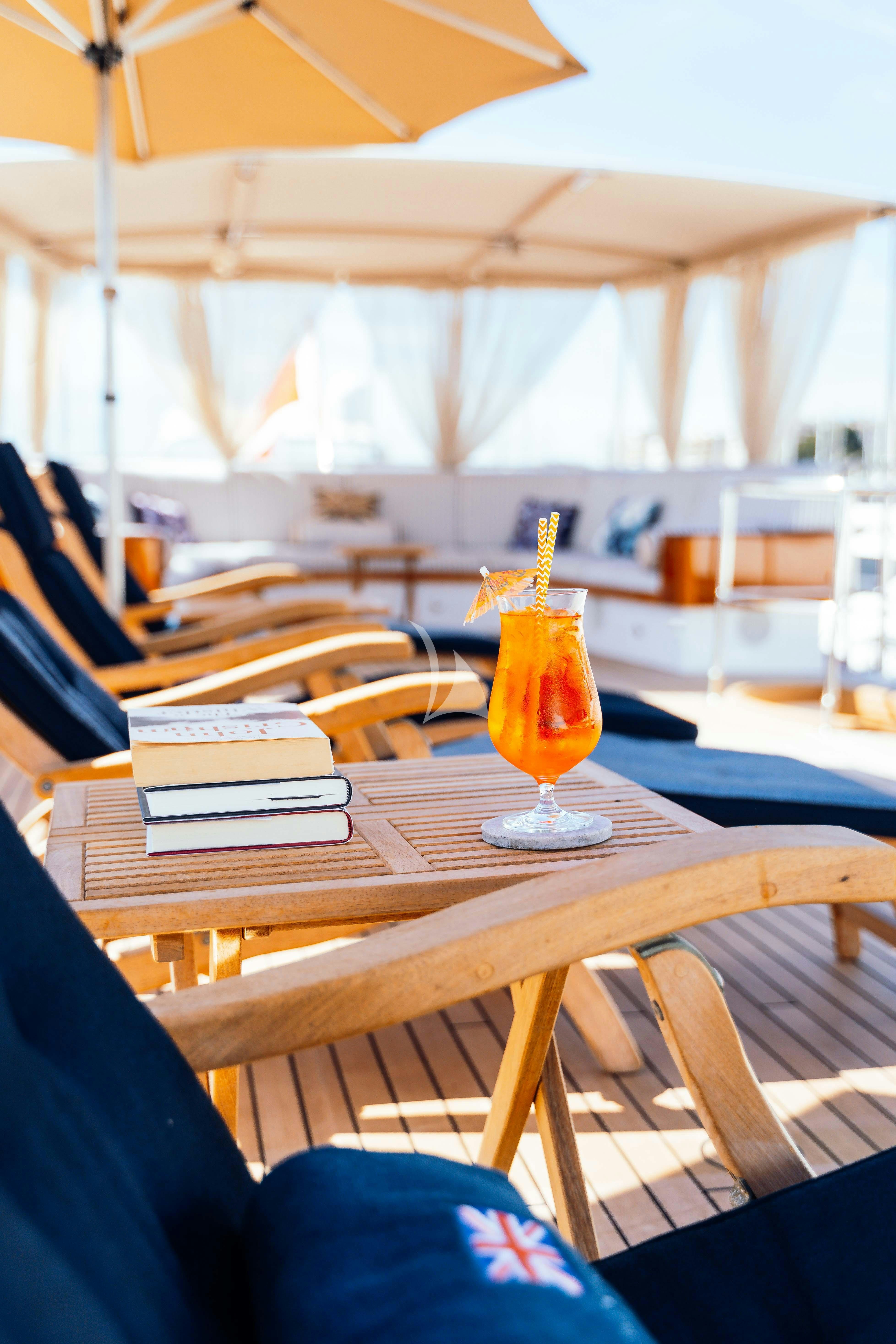 a glass of beer on a table aboard ODYSSEY III Yacht for Charter