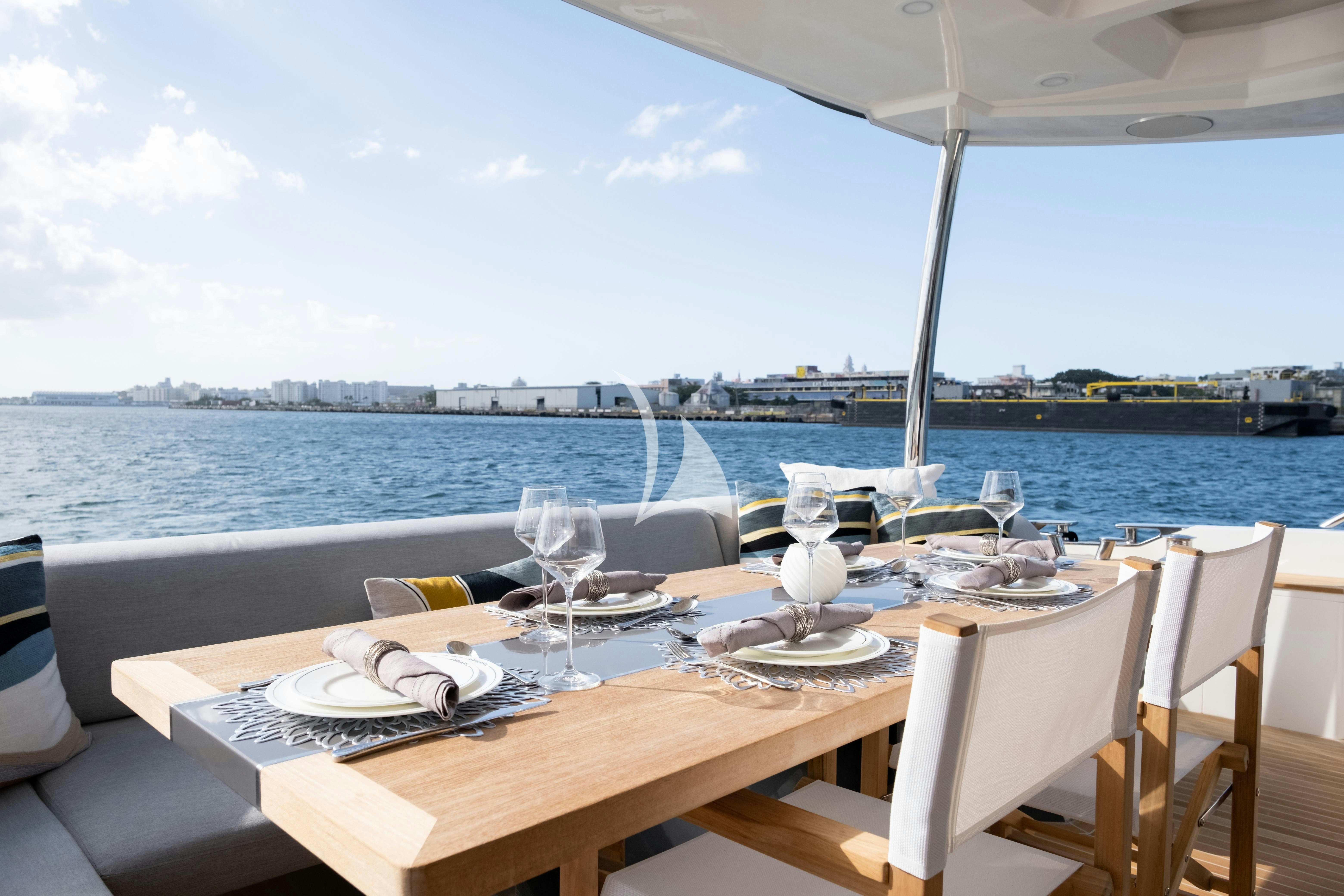 a table with plates and glasses on it aboard OMNIA Yacht for Charter