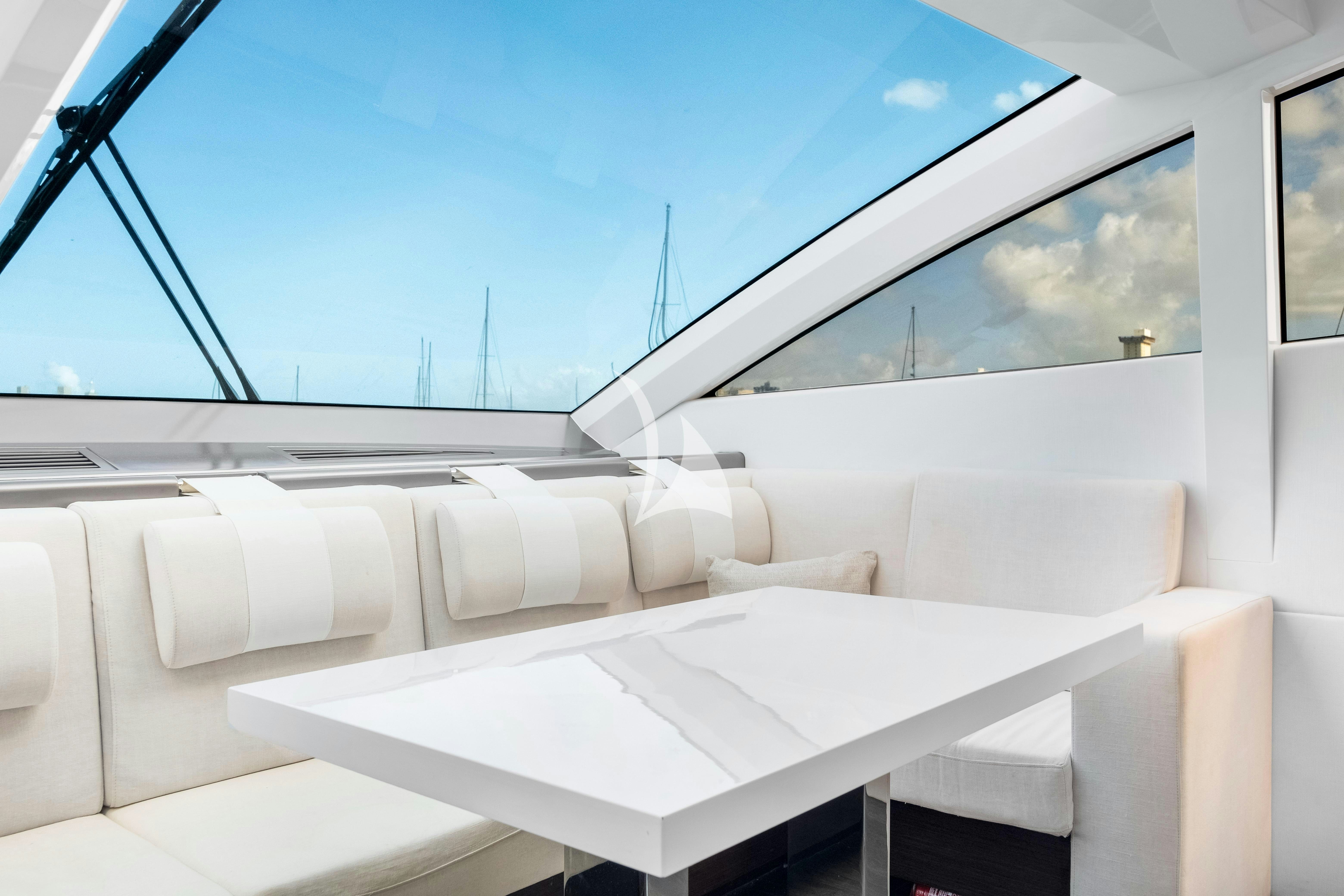 a white couch in a room aboard OMNIA Yacht for Charter