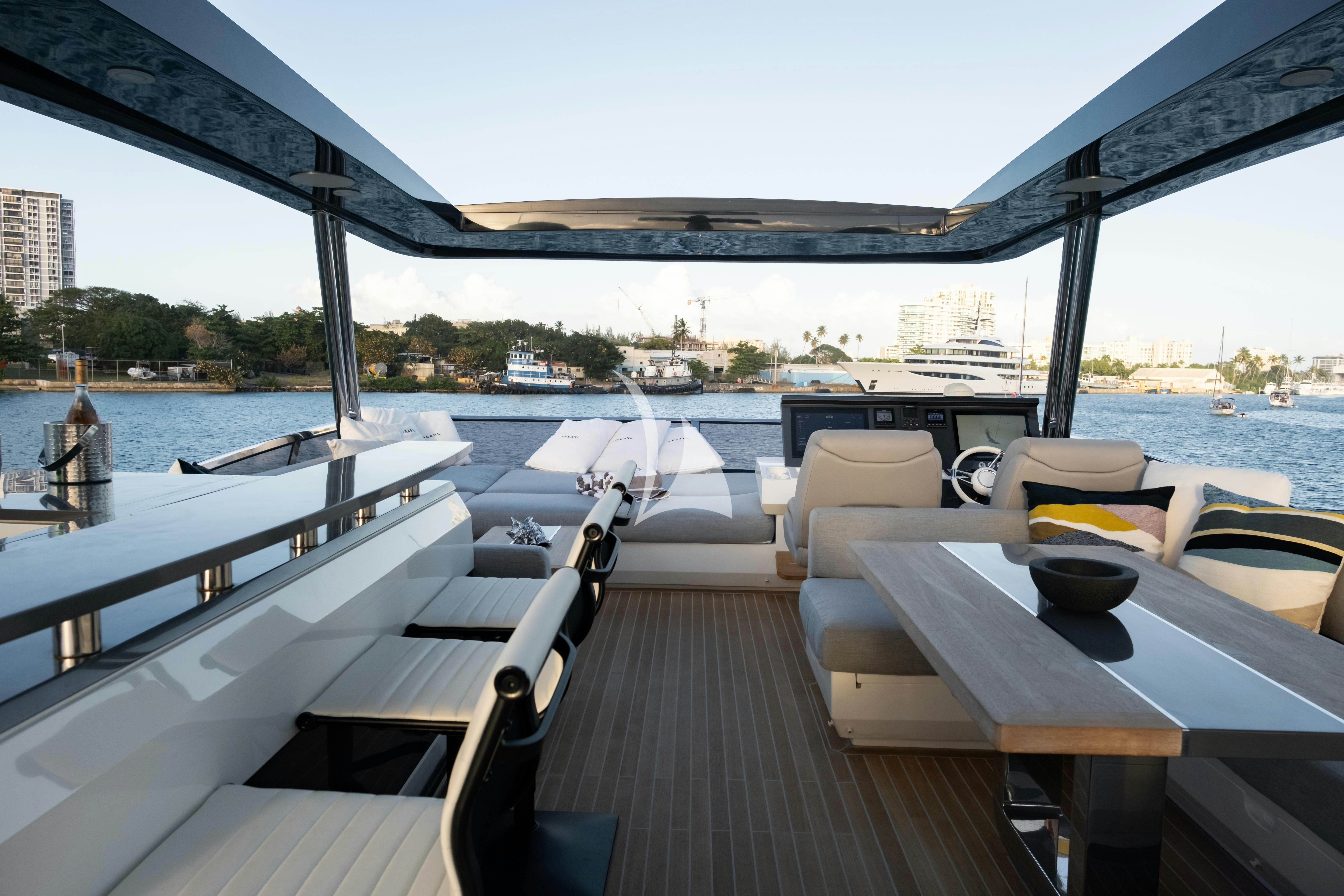 a deck with a view of a city and water aboard OMNIA Yacht for Charter