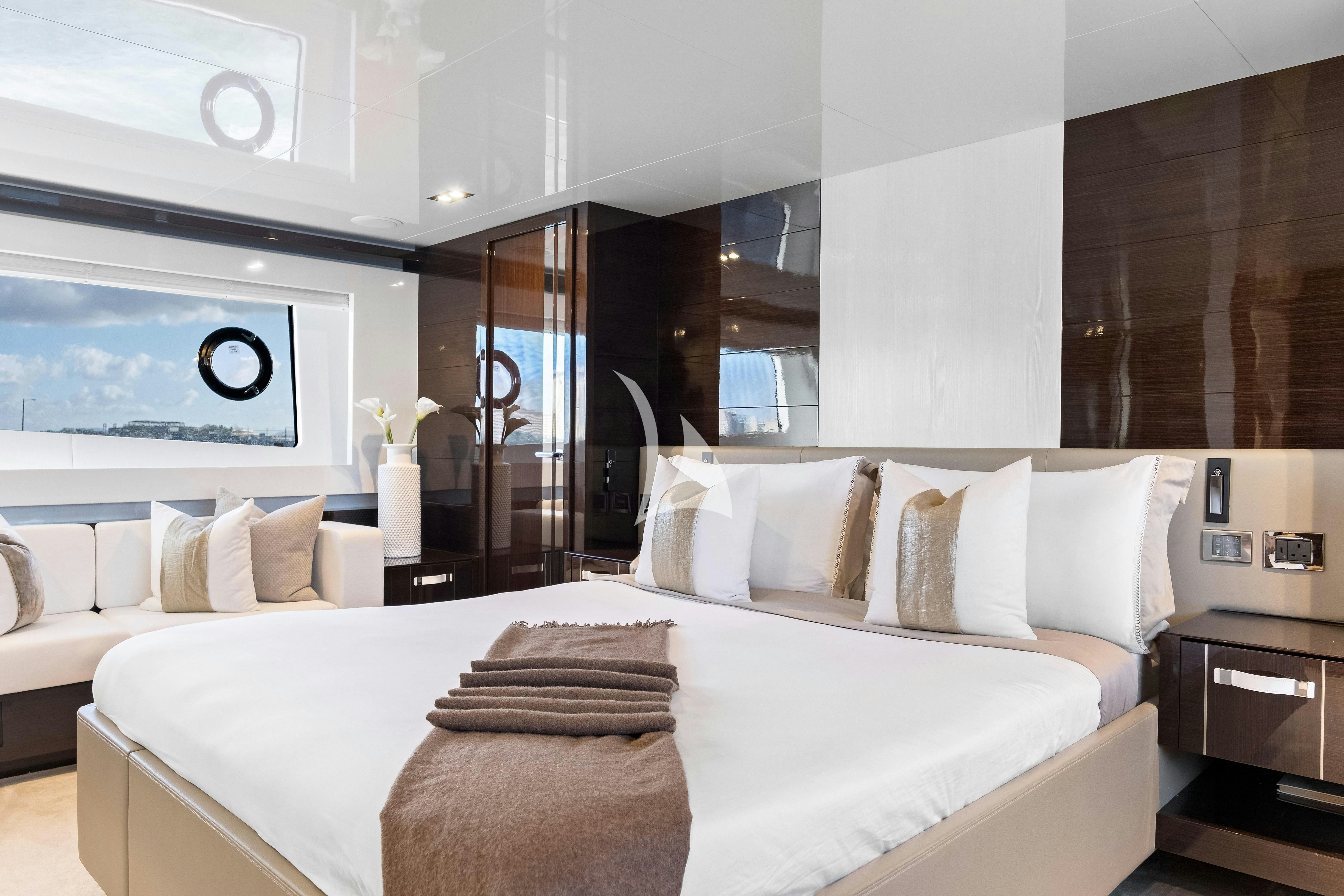 a large bed with white pillows aboard OMNIA Yacht for Charter