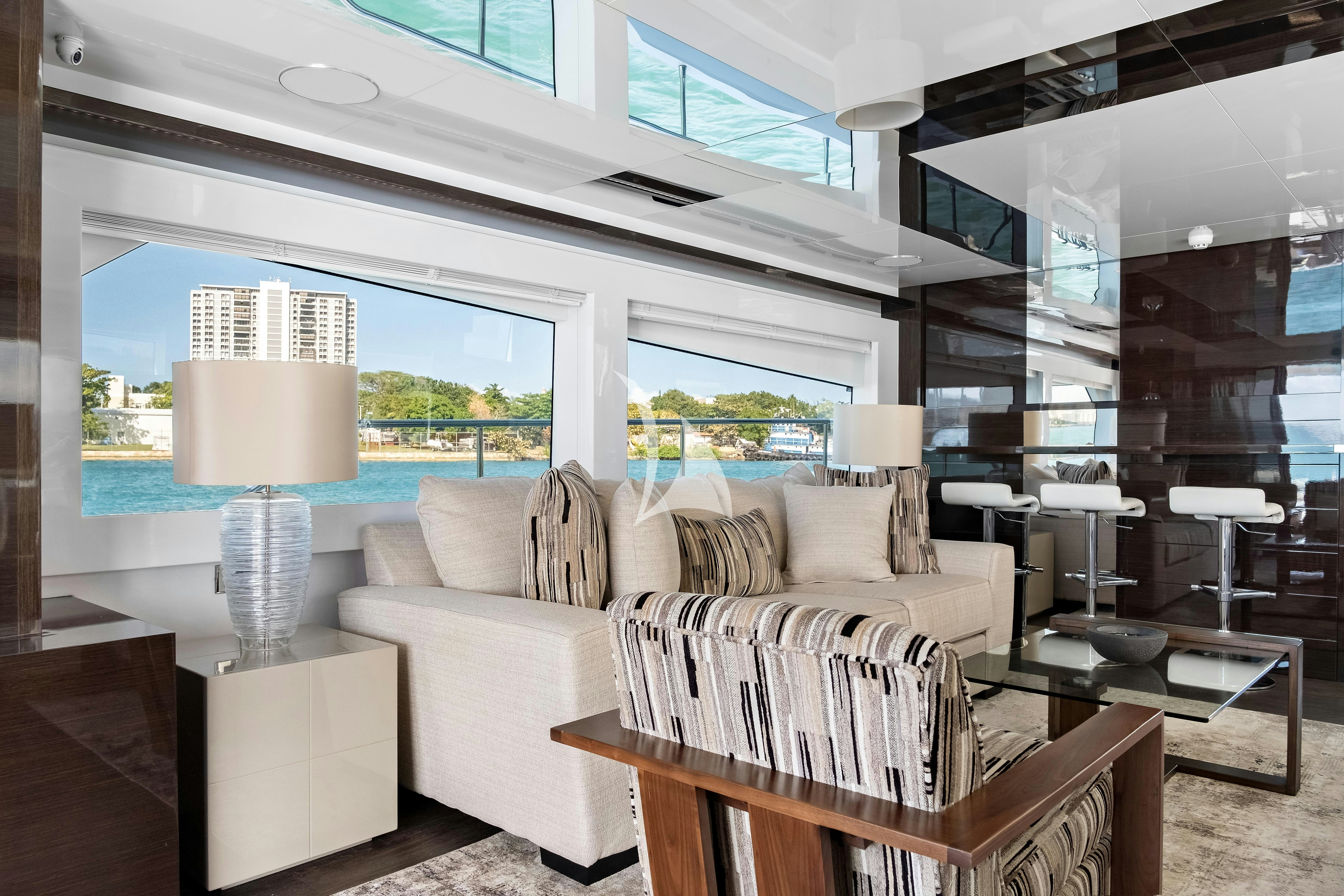 a living room with a large window aboard OMNIA Yacht for Charter