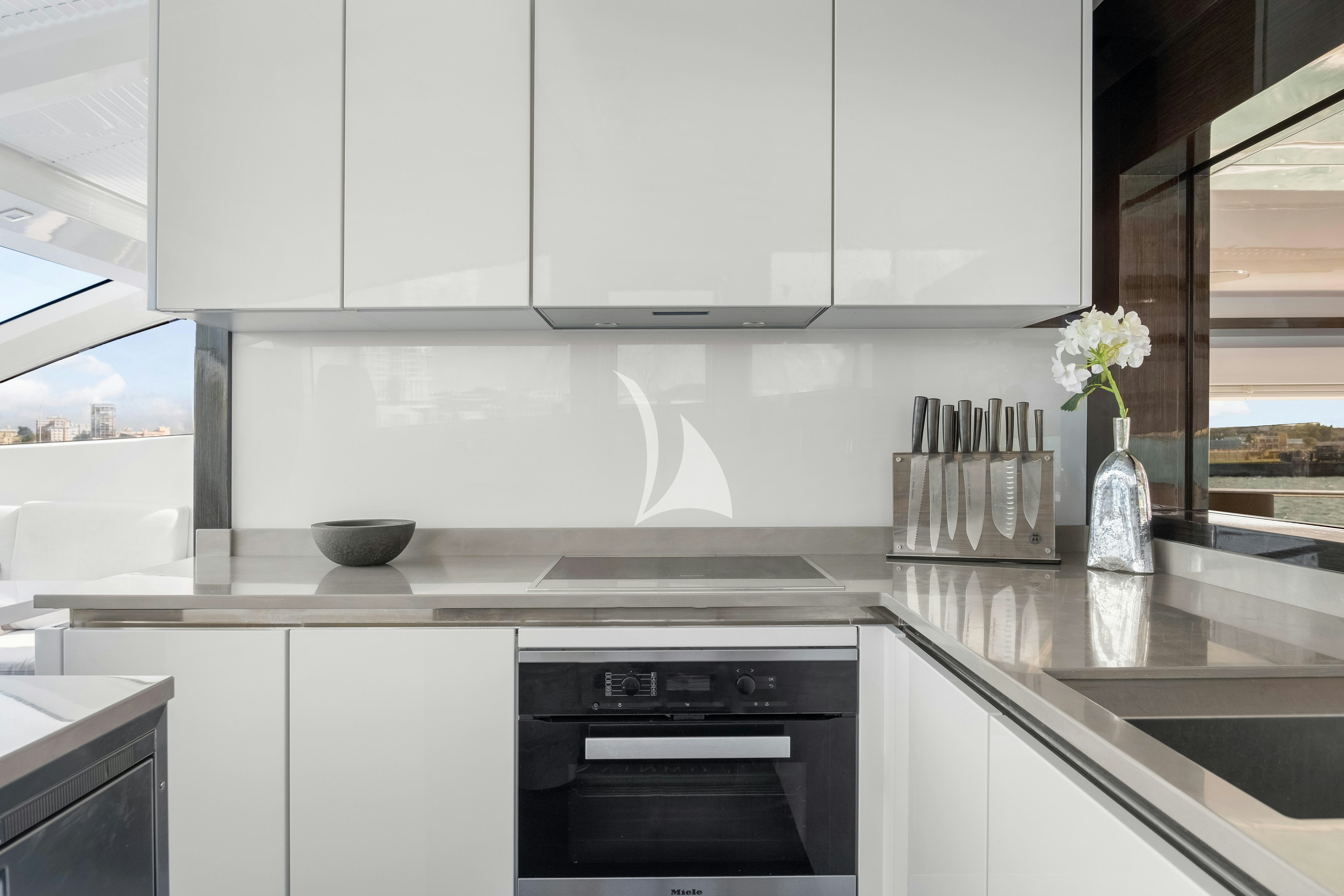 a kitchen with white cabinets aboard OMNIA Yacht for Charter