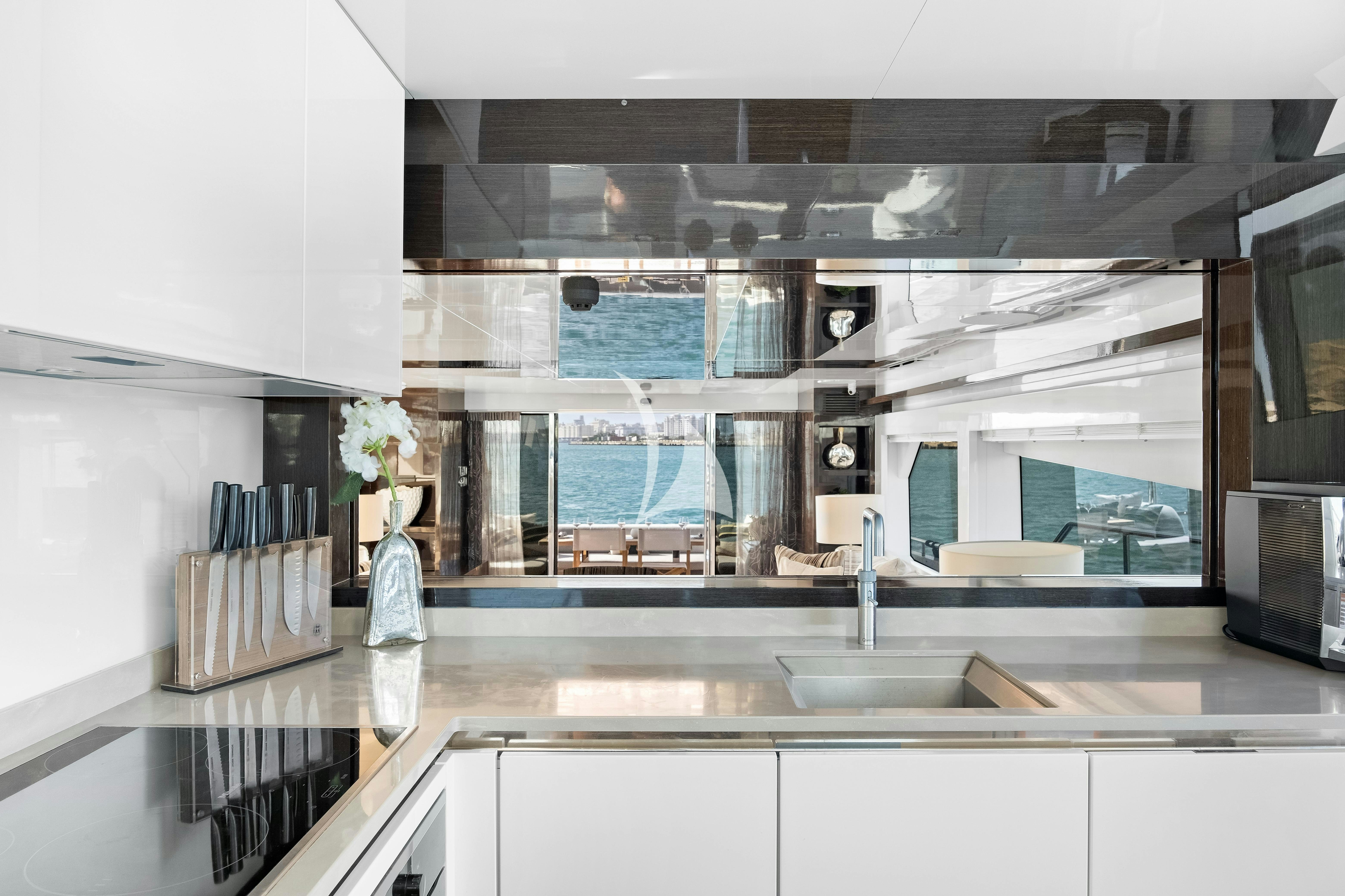 a kitchen with a sink and cabinets aboard OMNIA Yacht for Charter