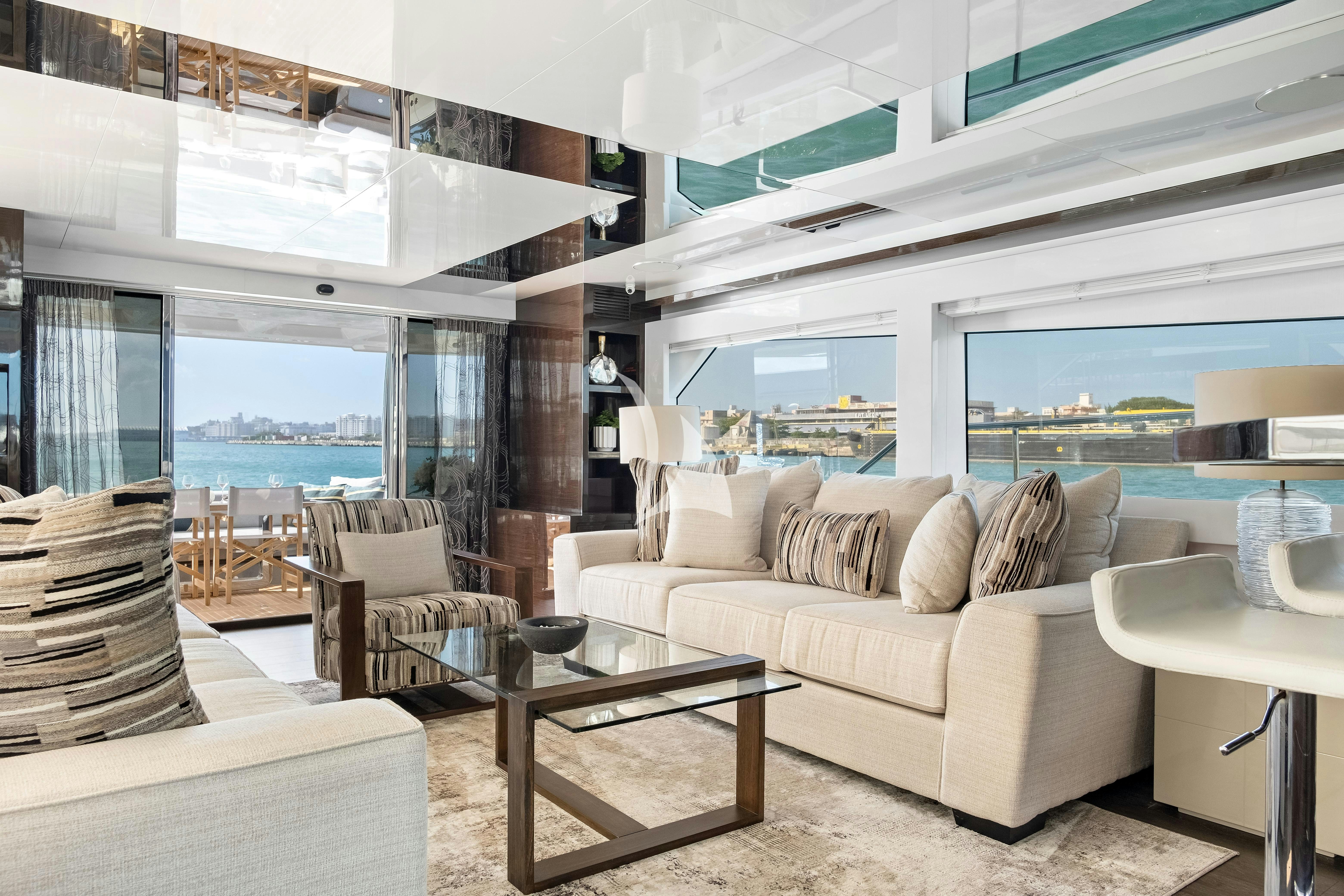 a living room with a large window aboard OMNIA Yacht for Charter