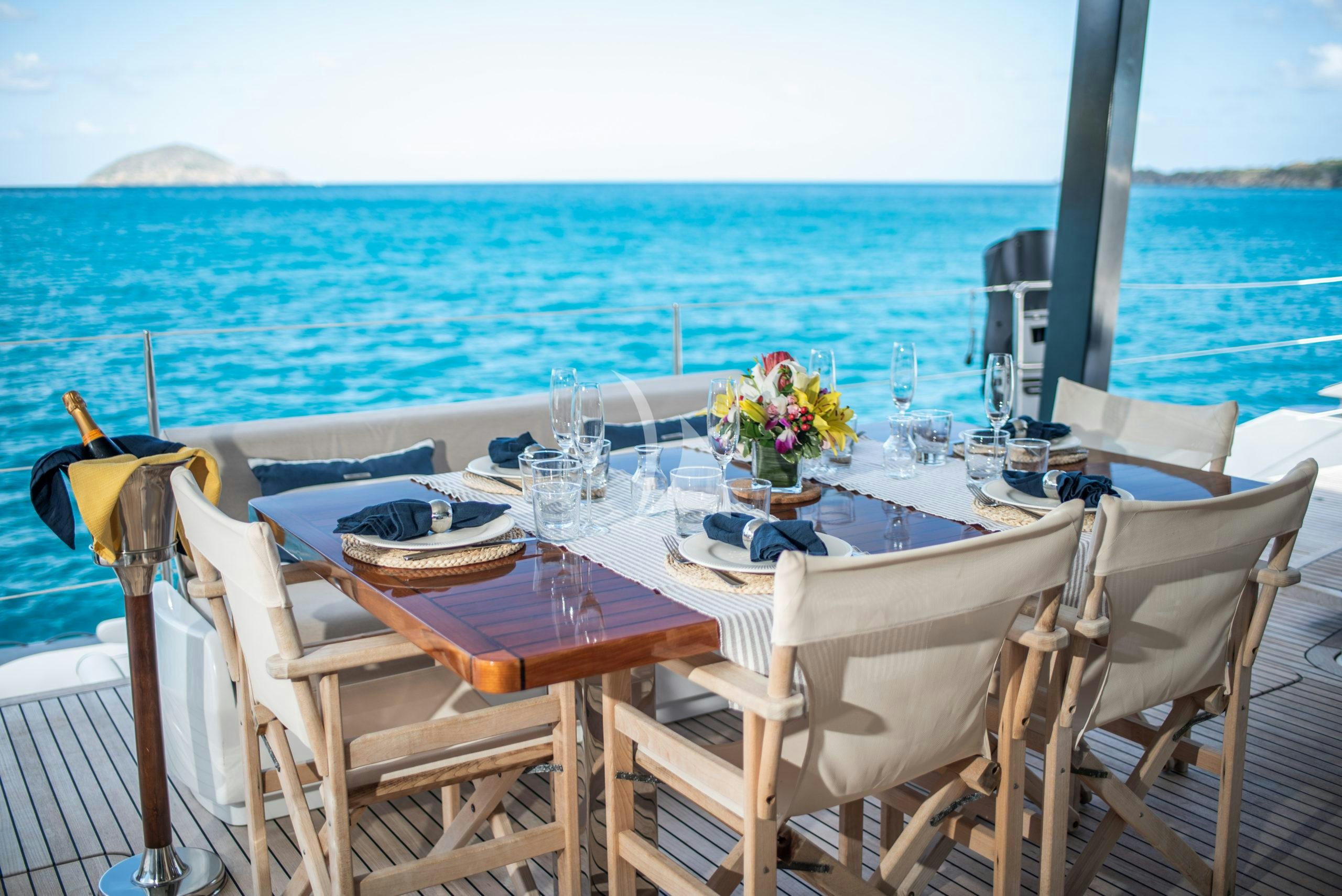 a table set for a dinner on the beach aboard BUNDALONG Yacht for Charter