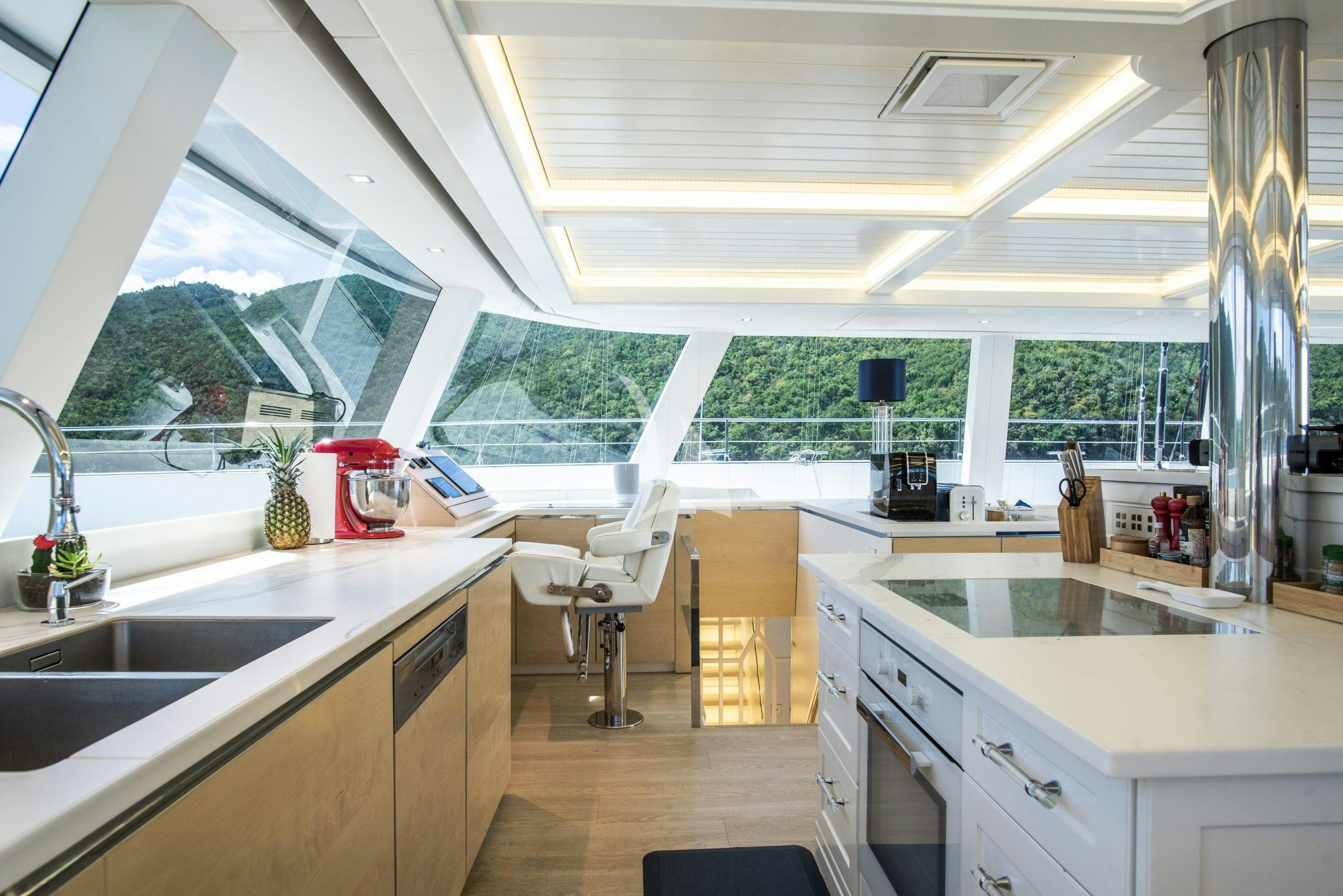 a kitchen with a large window aboard BUNDALONG Yacht for Charter