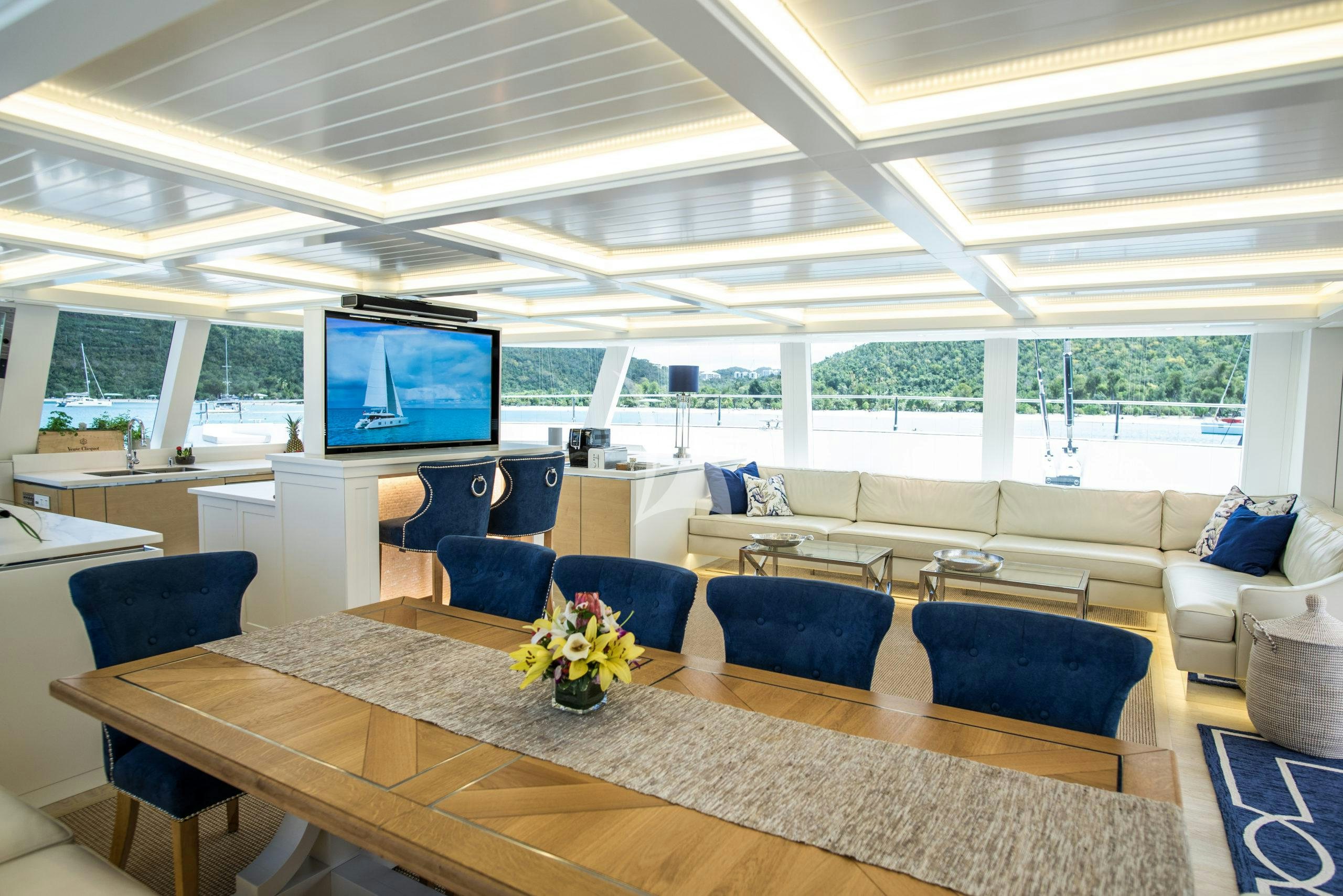 a large room with a table and chairs aboard BUNDALONG Yacht for Charter