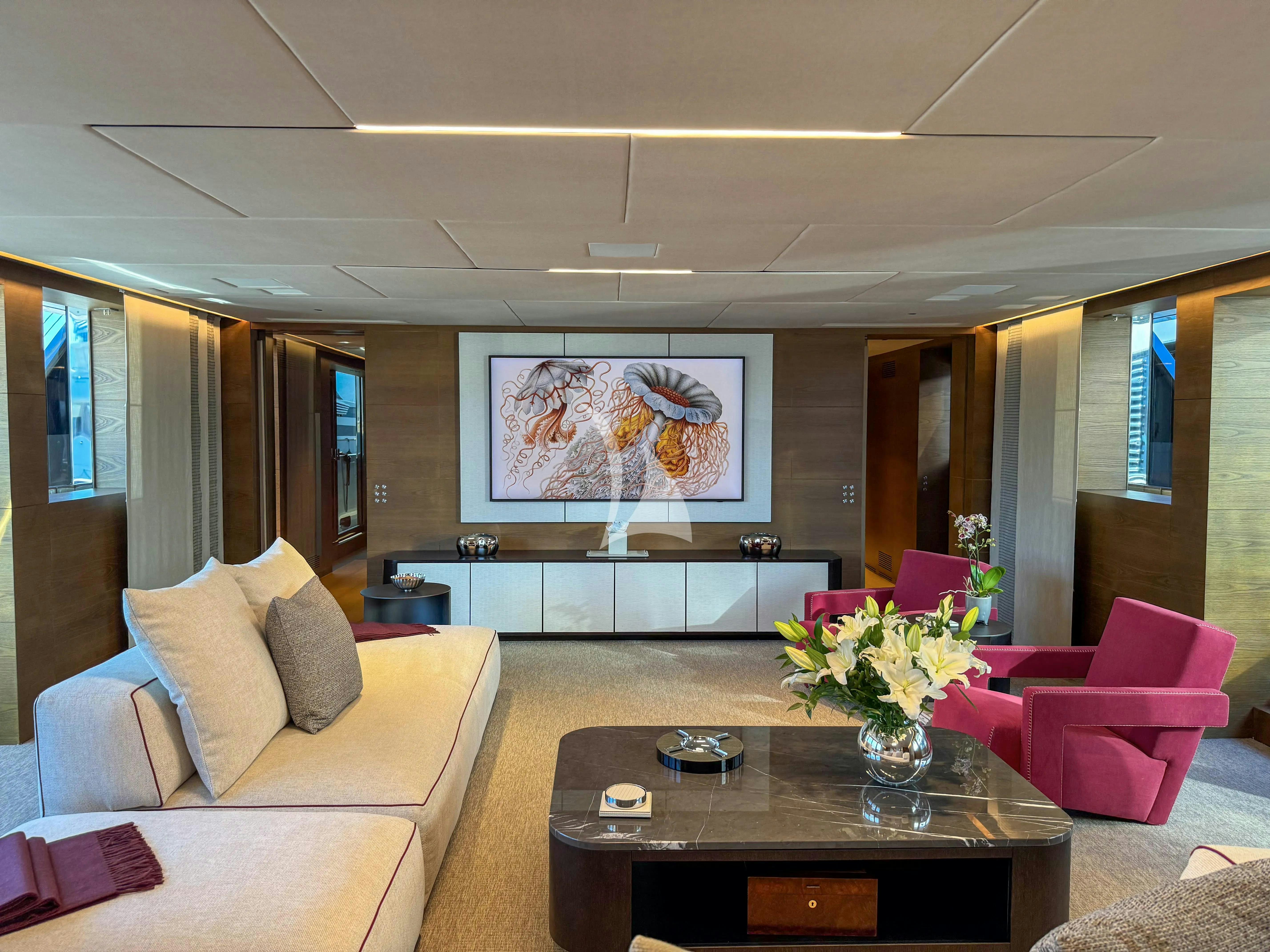 a living room with a table and couches aboard NAIA Yacht for Charter
