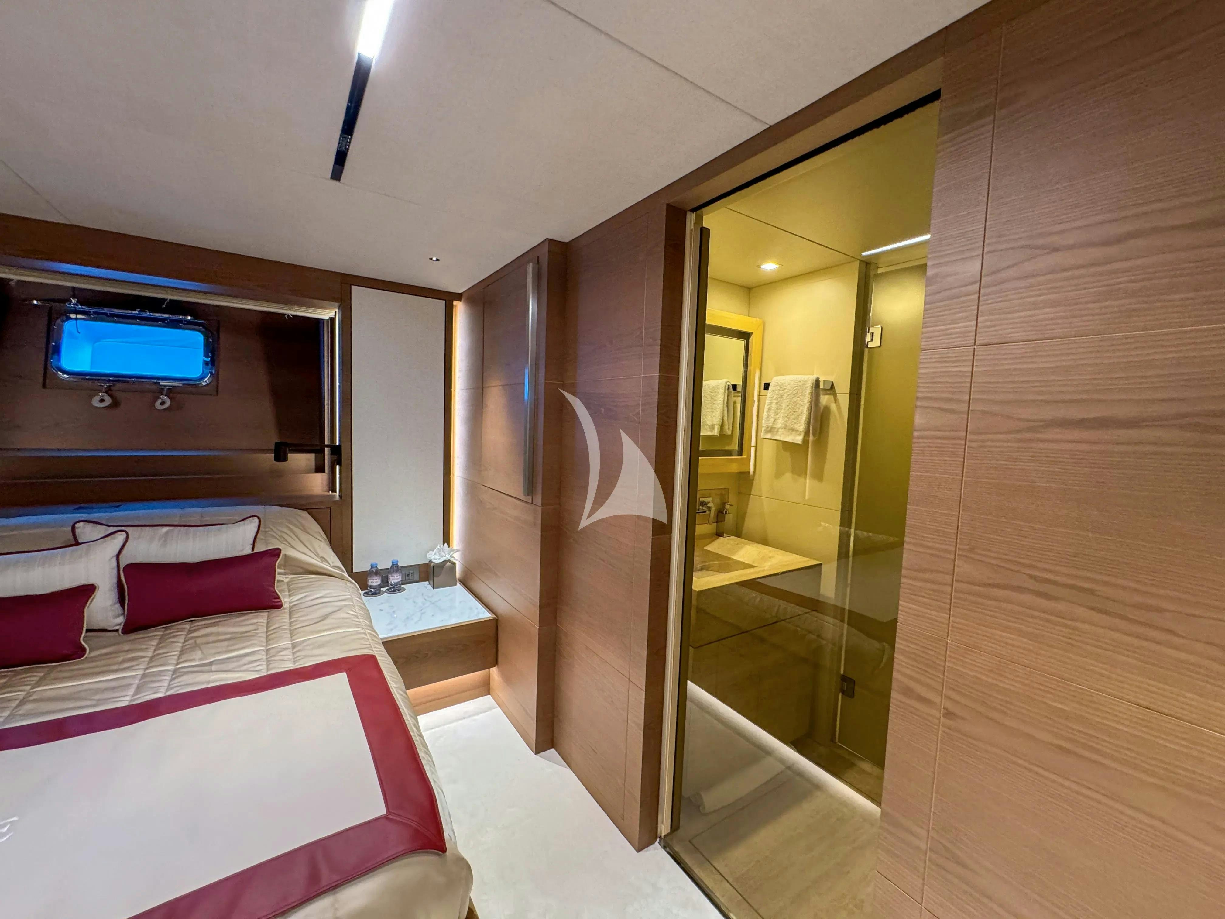 a room with a bed and a mirror aboard NAIA Yacht for Charter