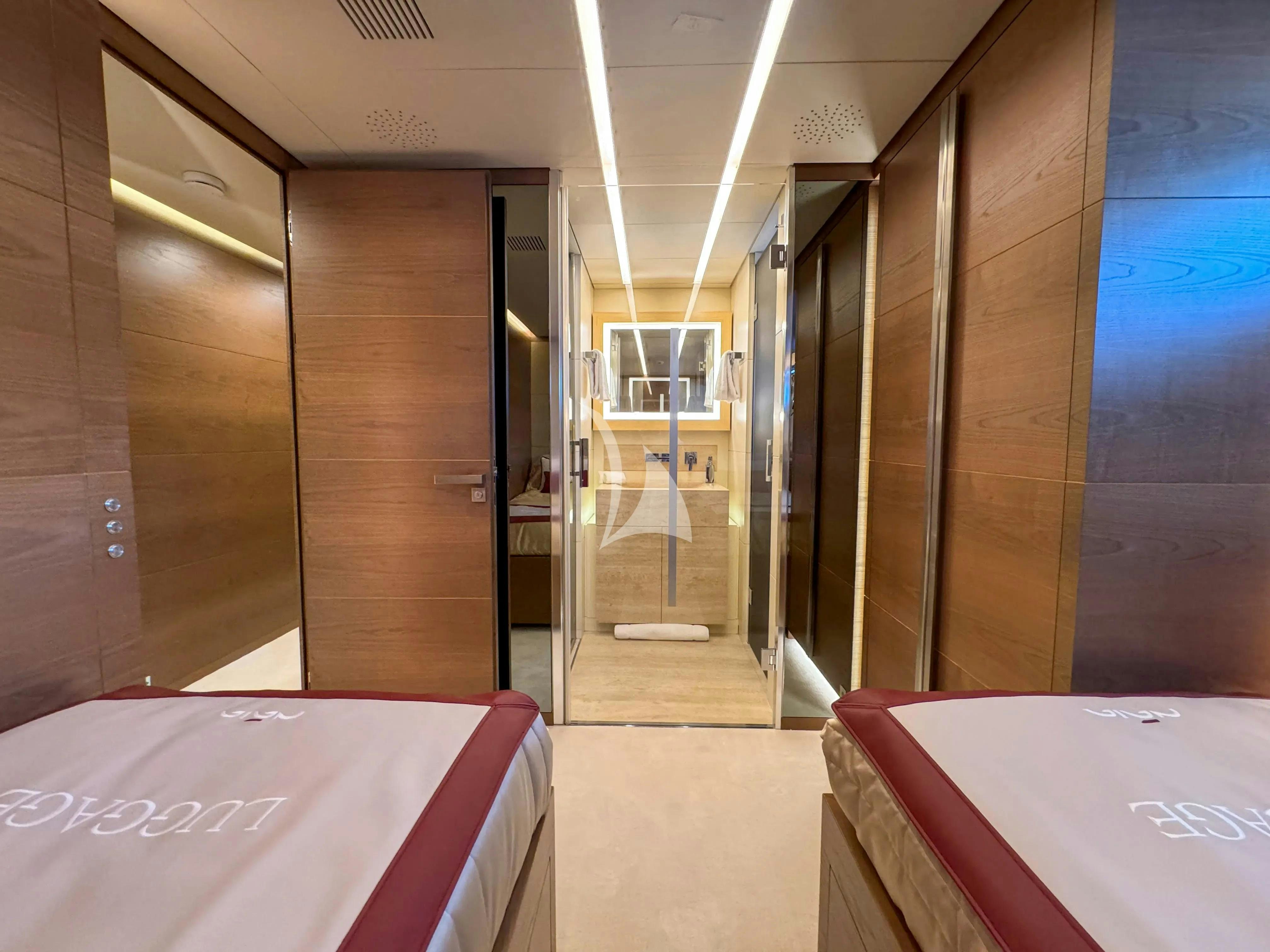 a room with a bed and a table aboard NAIA Yacht for Charter