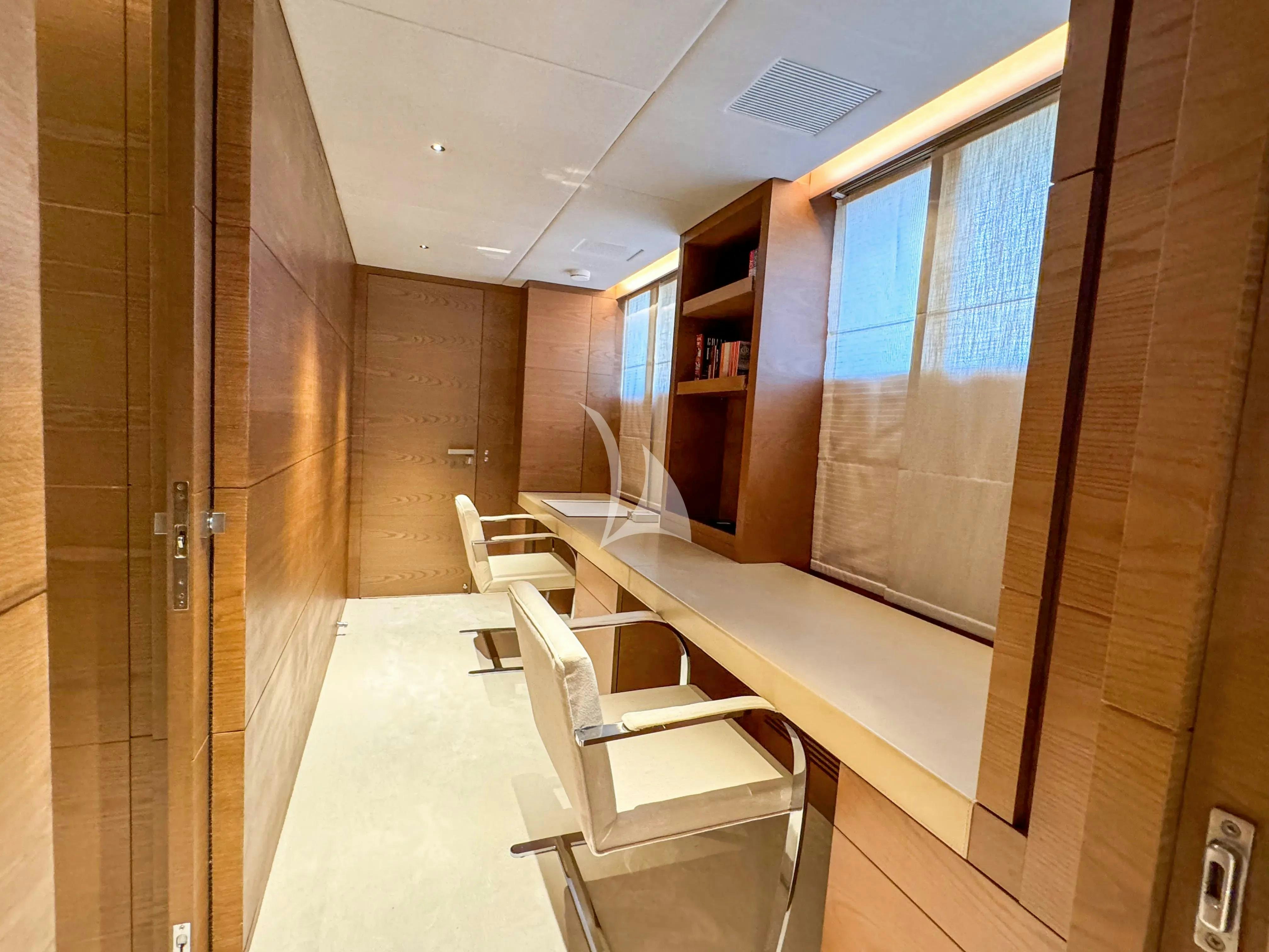 a room with a long table and chairs aboard NAIA Yacht for Charter