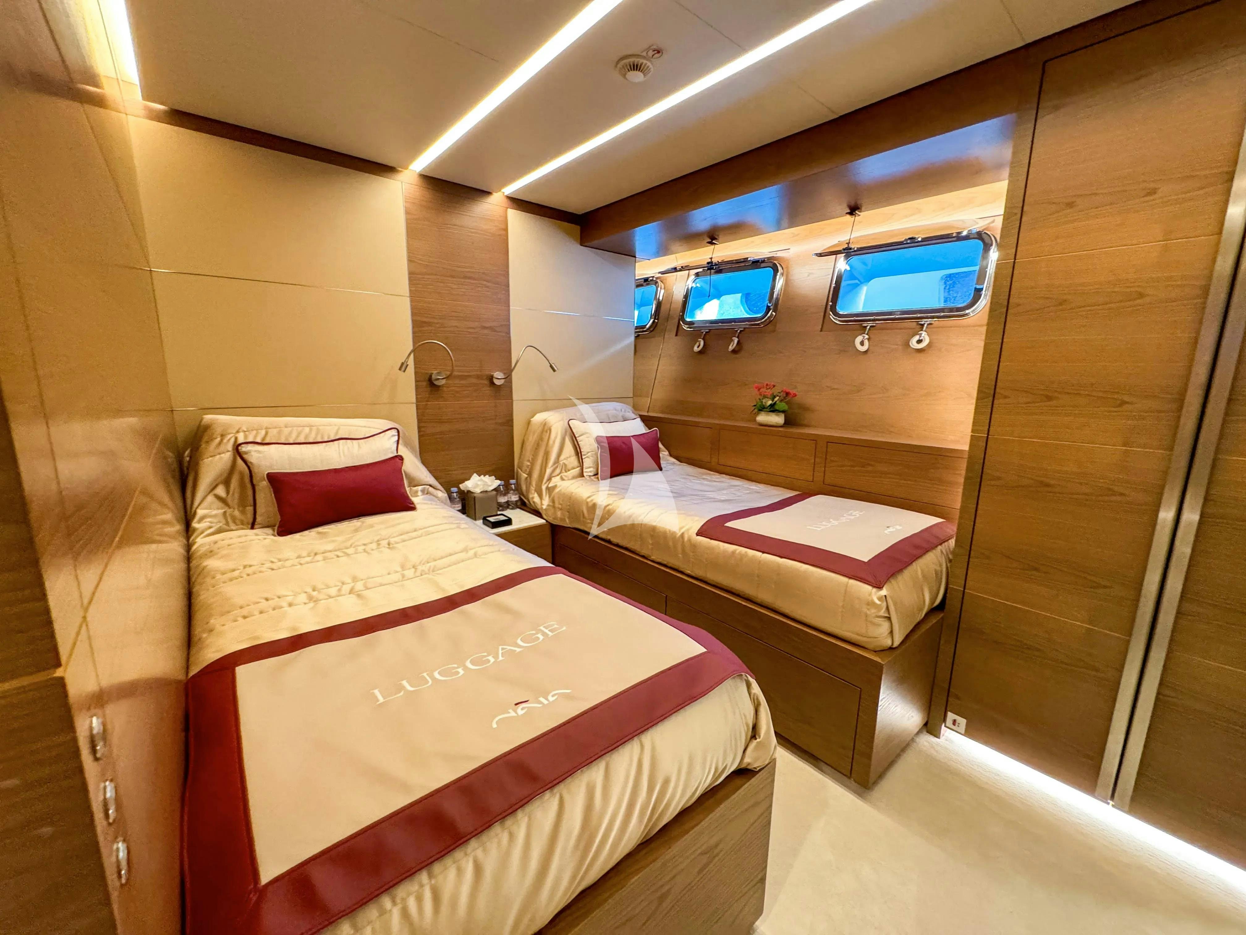 a room with a bed and a tv aboard NAIA Yacht for Charter