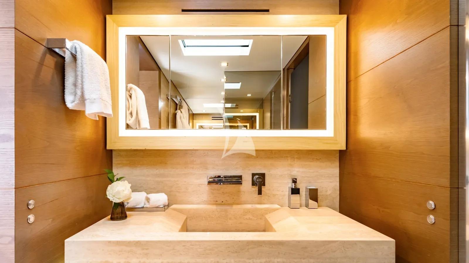 a bathroom with a large mirror aboard NAIA Yacht for Charter