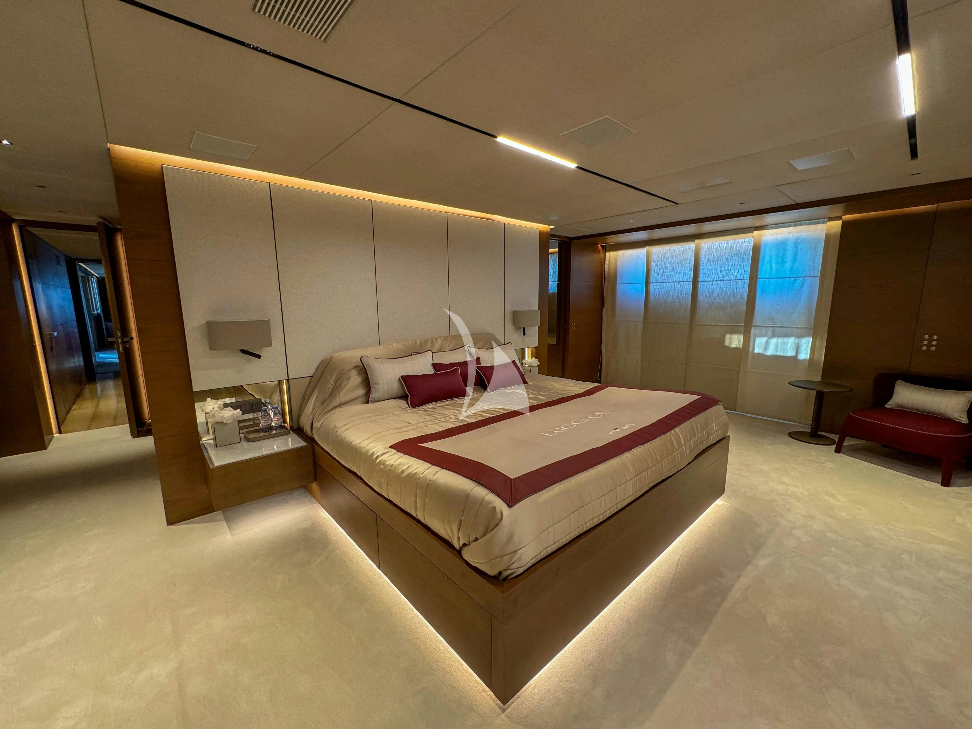 a room with a bed and a desk aboard NAIA Yacht for Charter