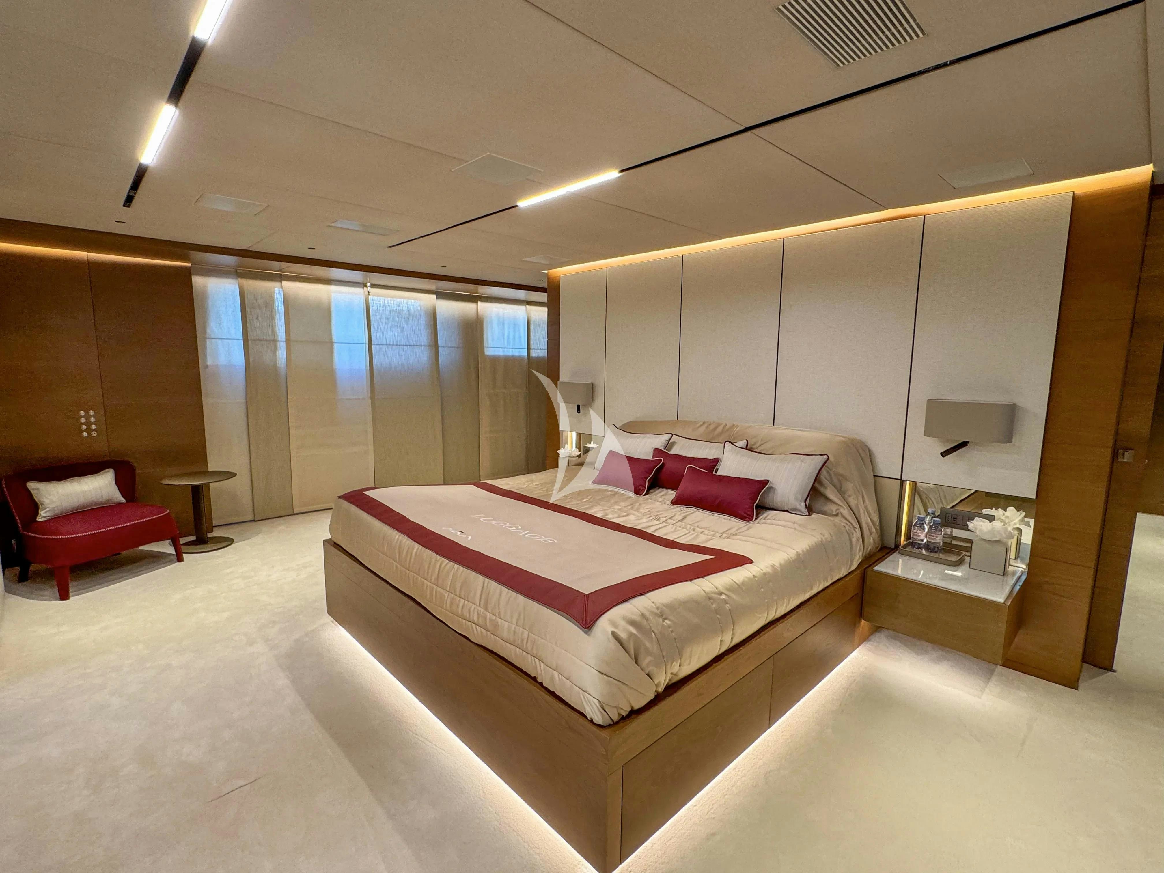 a room with a bed and a desk aboard NAIA Yacht for Charter