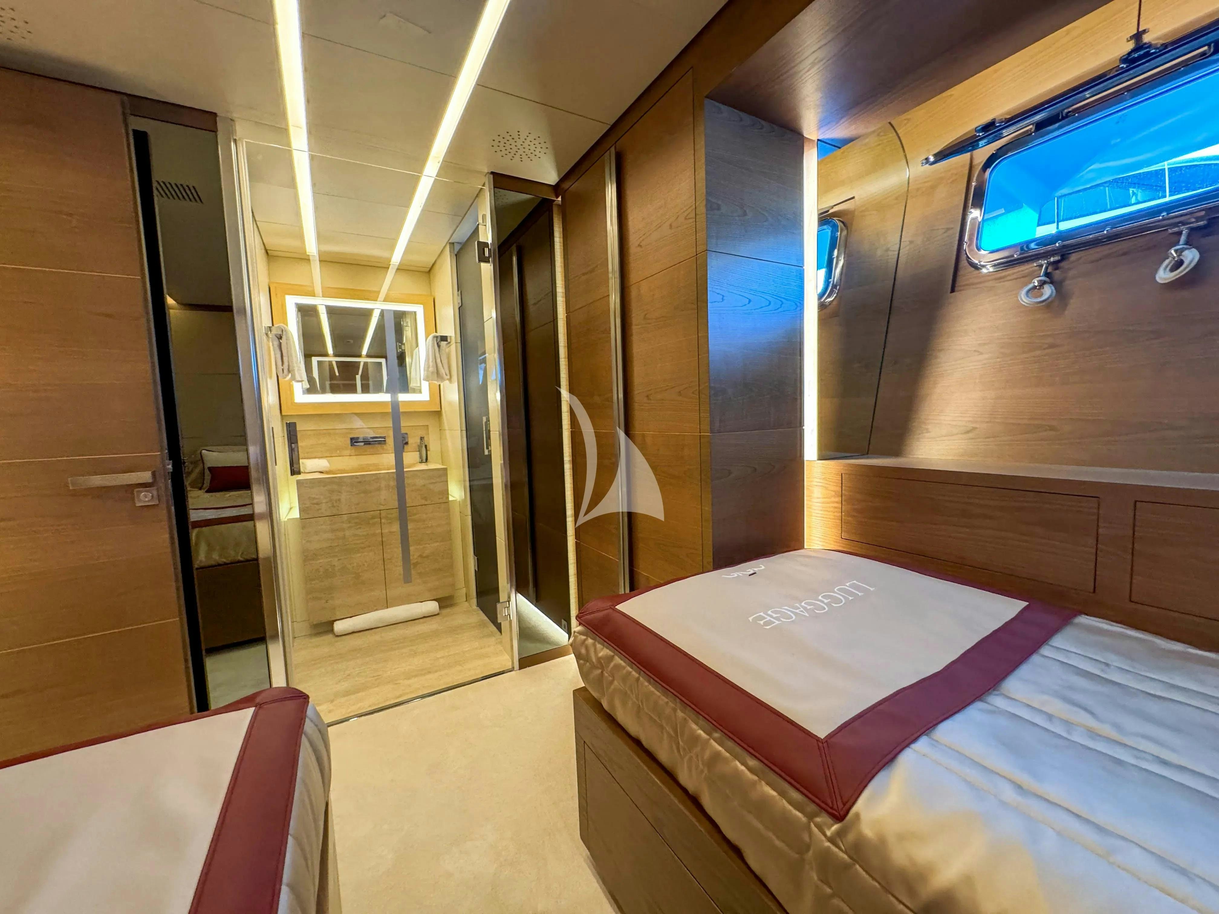 a room with a bed and a window aboard NAIA Yacht for Charter
