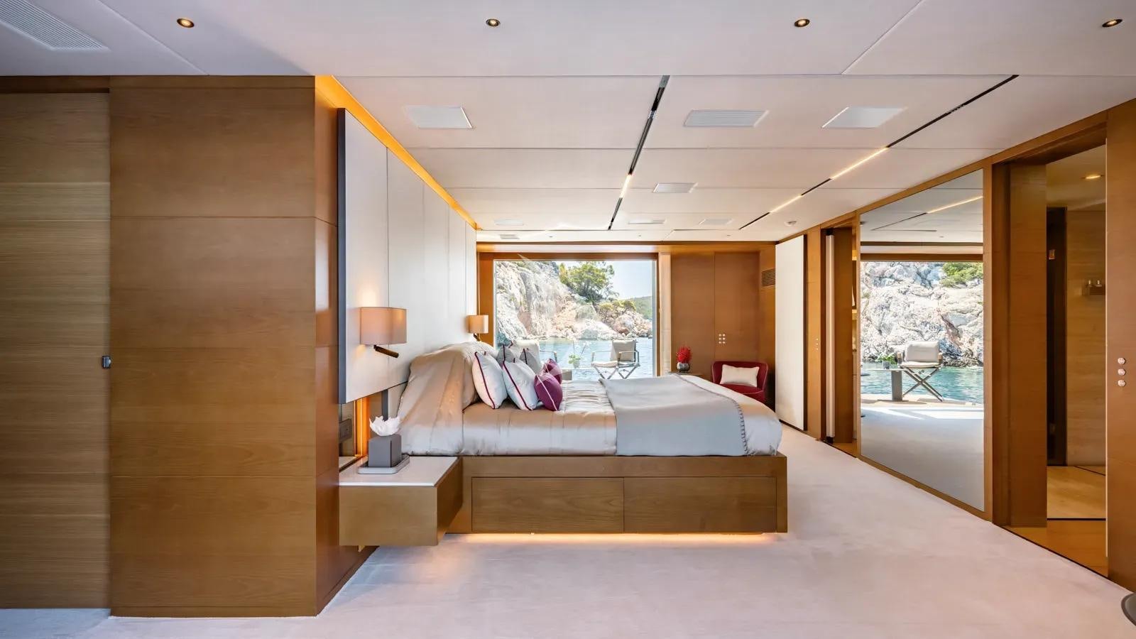 a room with a bed and a window aboard NAIA Yacht for Charter