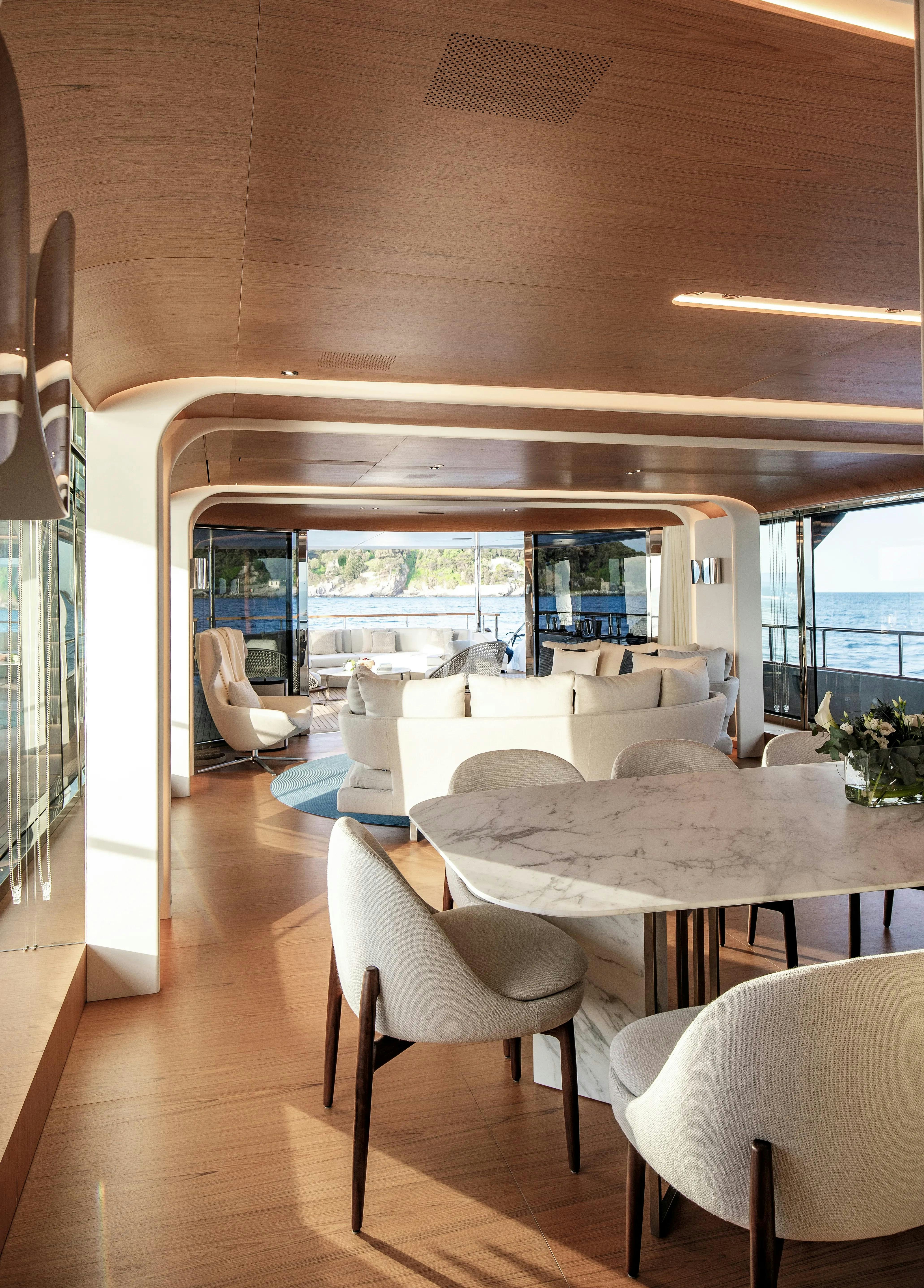 a room with a table and chairs aboard LEGEND Yacht for Charter
