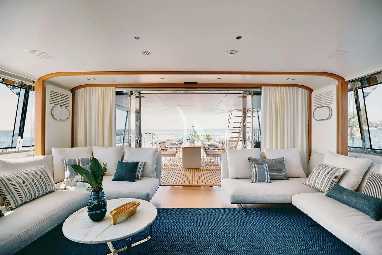a living room with a large window aboard LEGEND Yacht for Charter